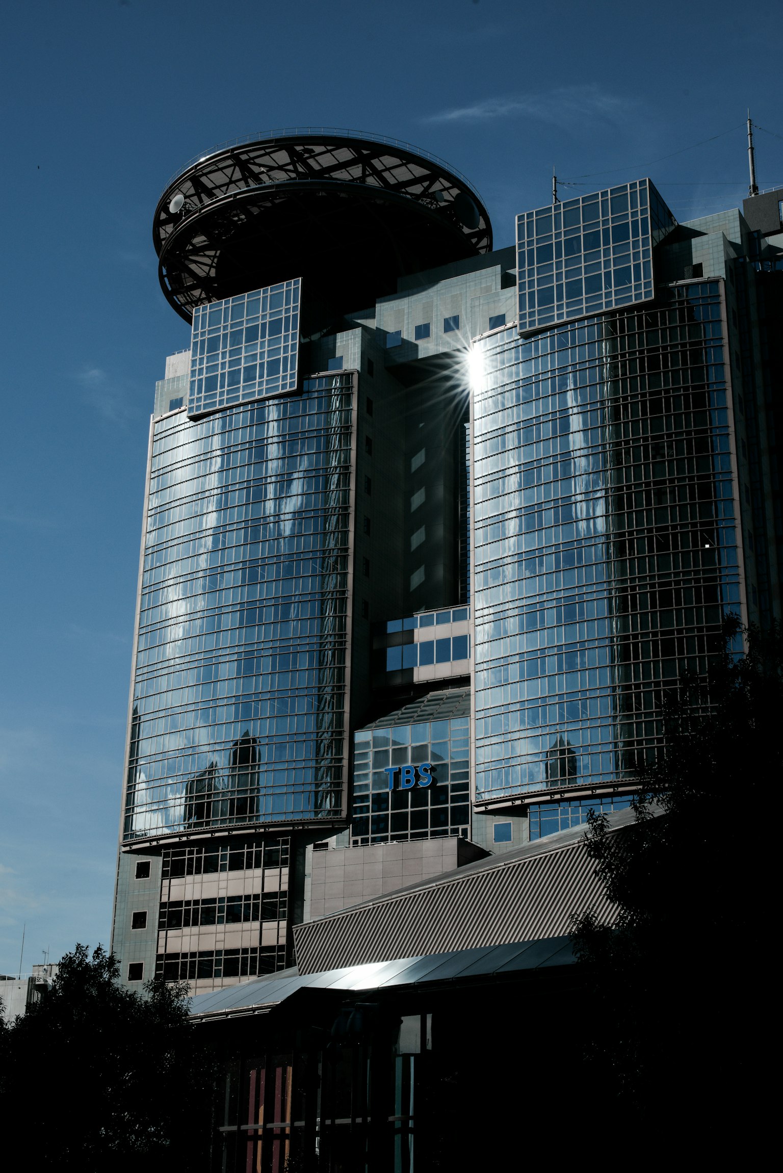 Edificio de gran altura con fachada de vidrio y estructura de techo circular