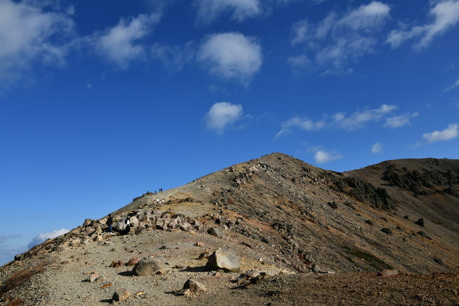 Mountain landscape under blue sky with rocky terrain