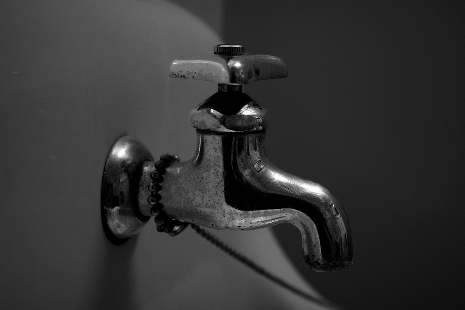 Metal faucet against a black and white background