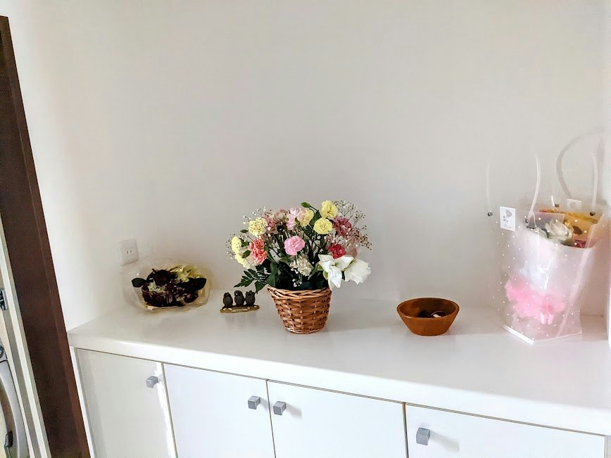 flower basket and small decor on a white shelf