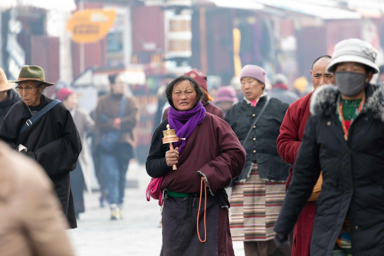 People walking on a busy street wearing traditional clothing