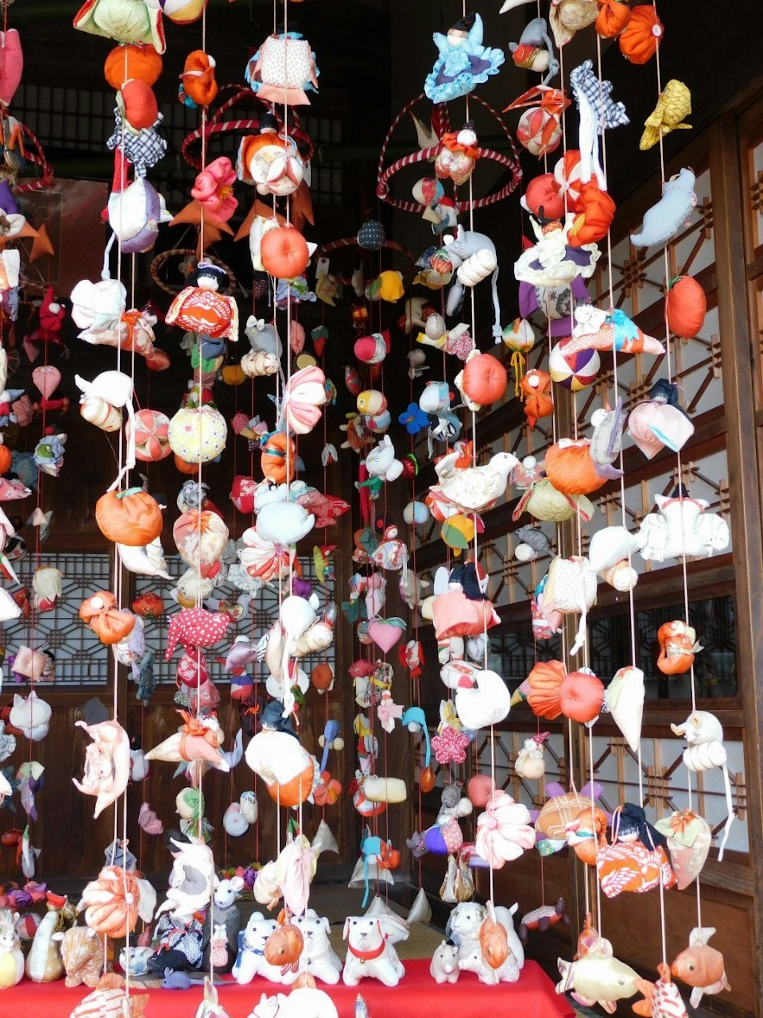 Colorful small dolls hanging in a traditional Japanese decoration