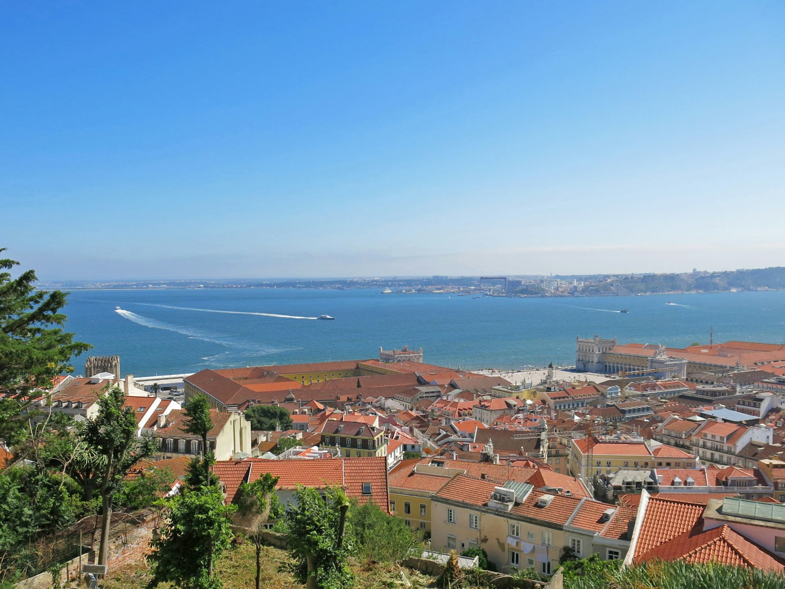 Pemandangan indah Lisbon dengan bangunan atap merah dan laut
