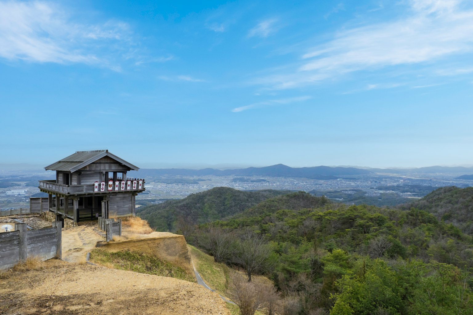 Traditional house on a mountain with expansive green landscape