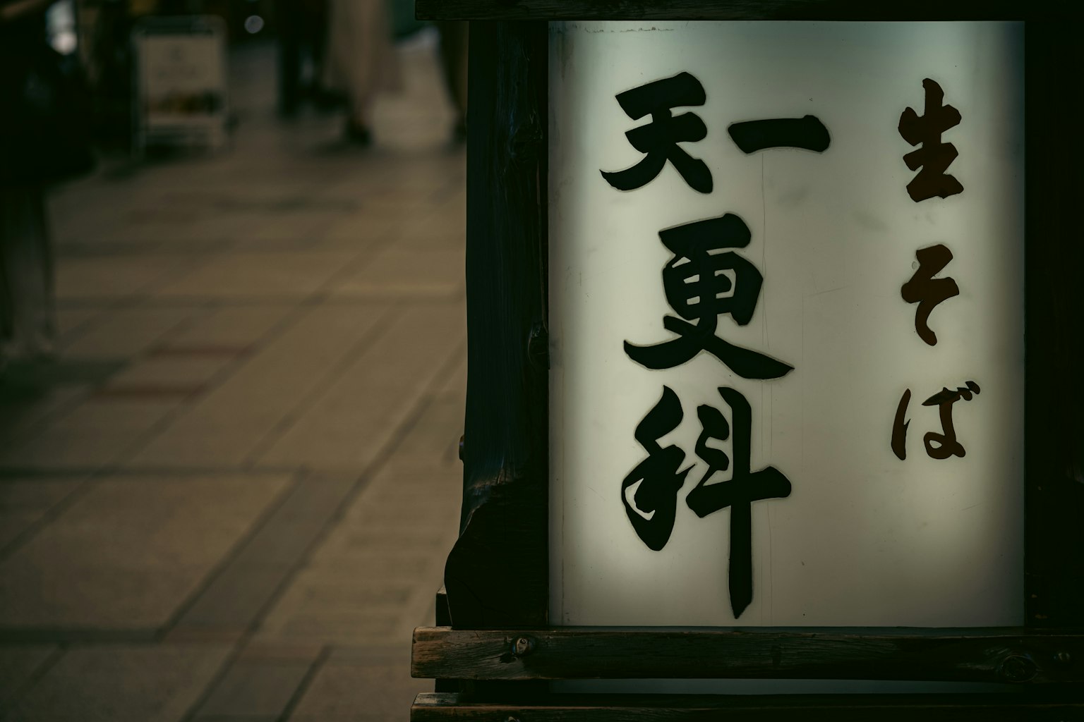 Una scena di strada con un'insegna per soba freschi al Tenko