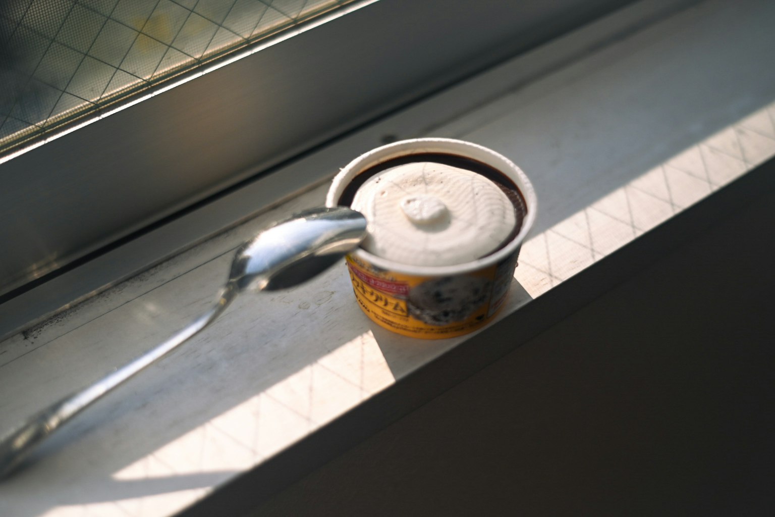 Image of a can with a spoon placed on a windowsill