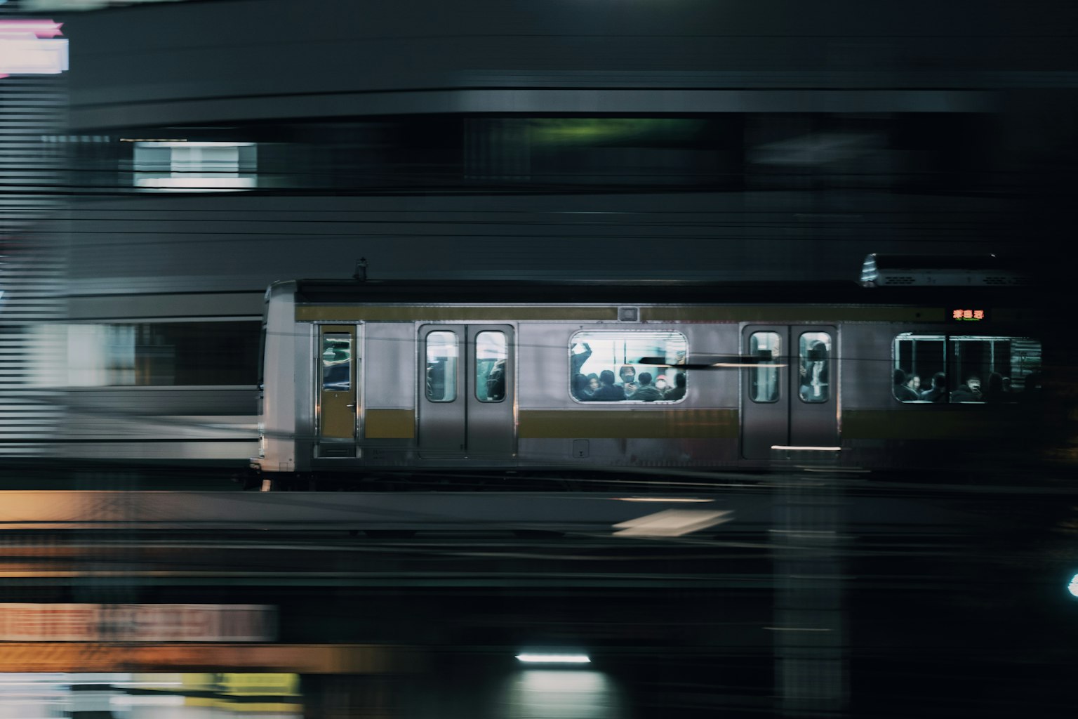 A motion blur of a train passing through a city at night