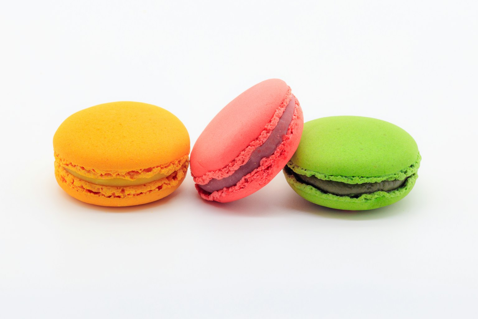 Colorful set of macarons featuring orange, pink, and green macarons