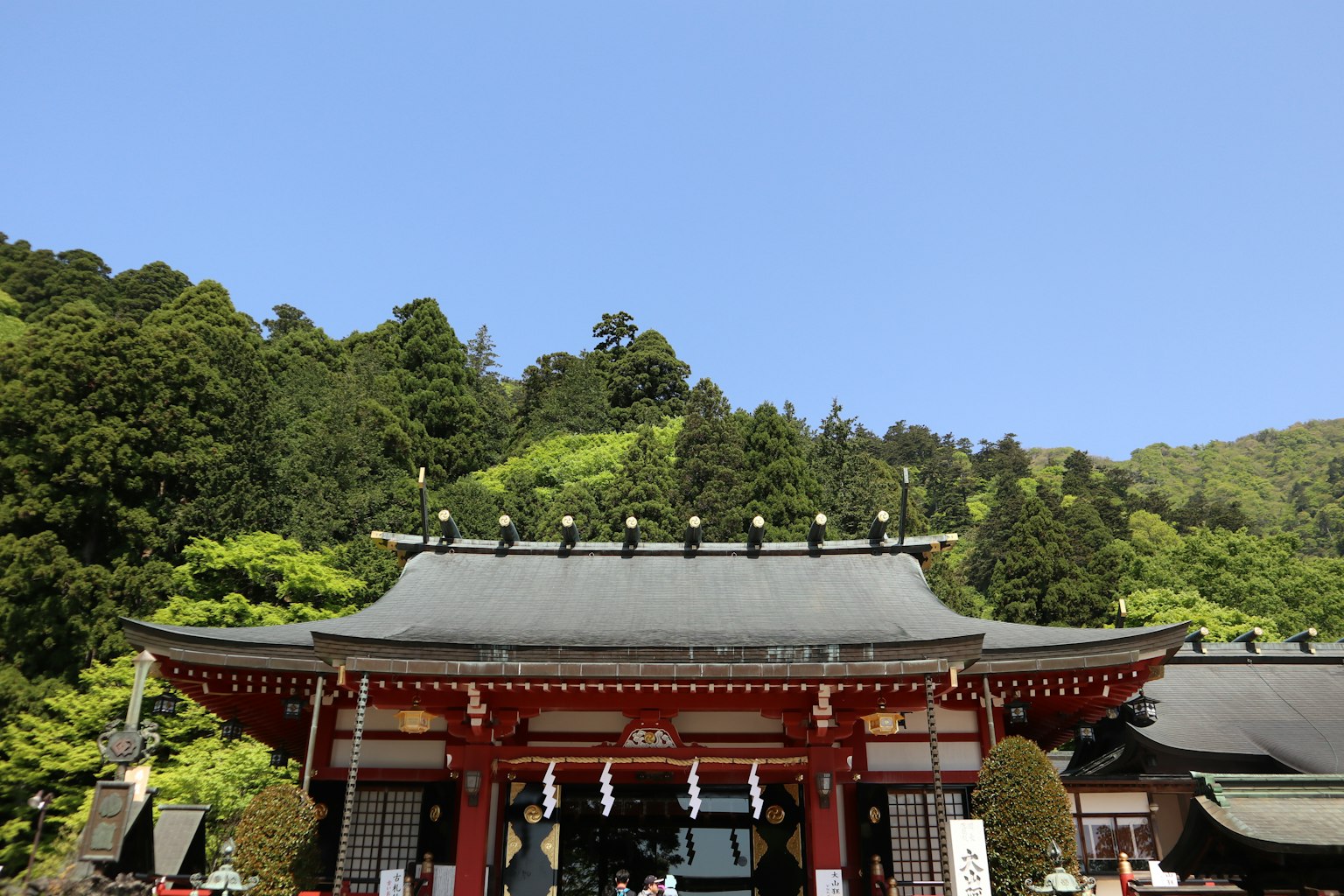 A beautiful shrine building with green hills in the background