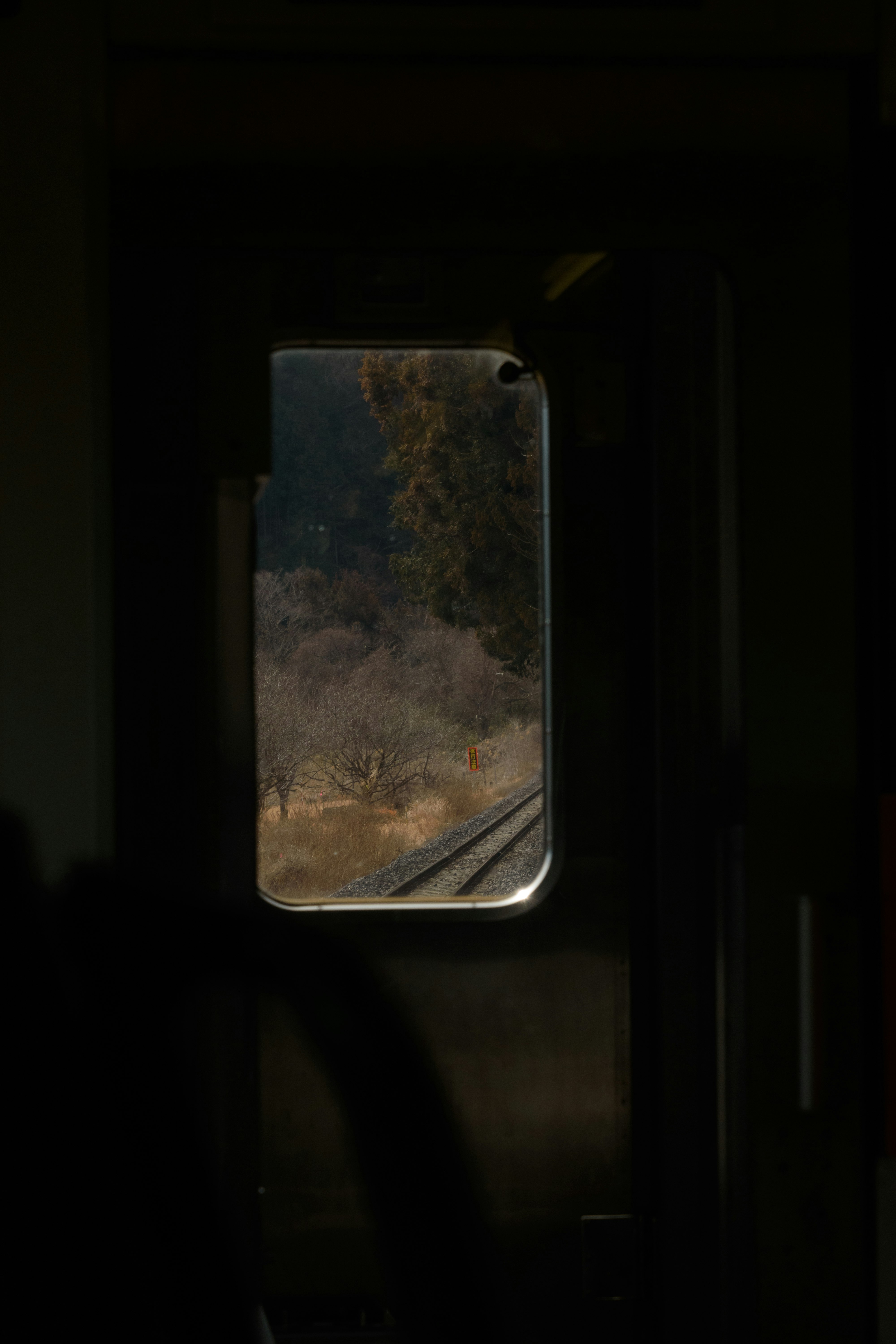 View from a train window at an unmanned local station while listening to a diesel engine