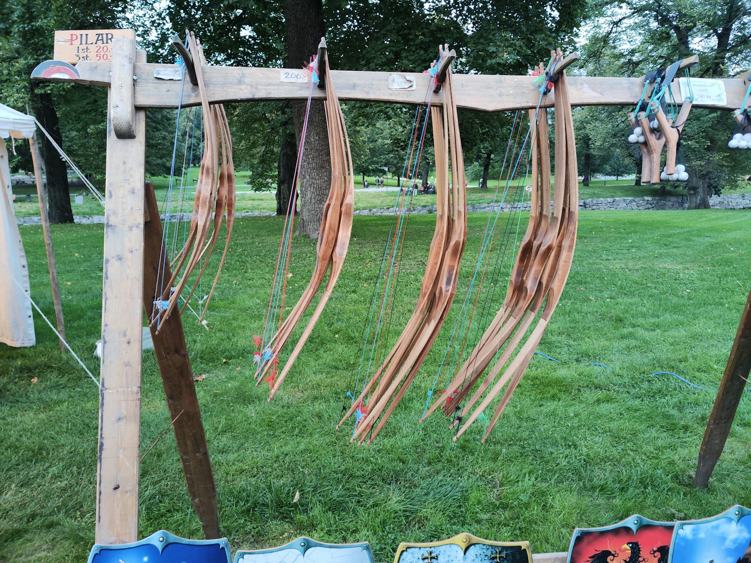Display stand with wooden bows arranged in a grassy area