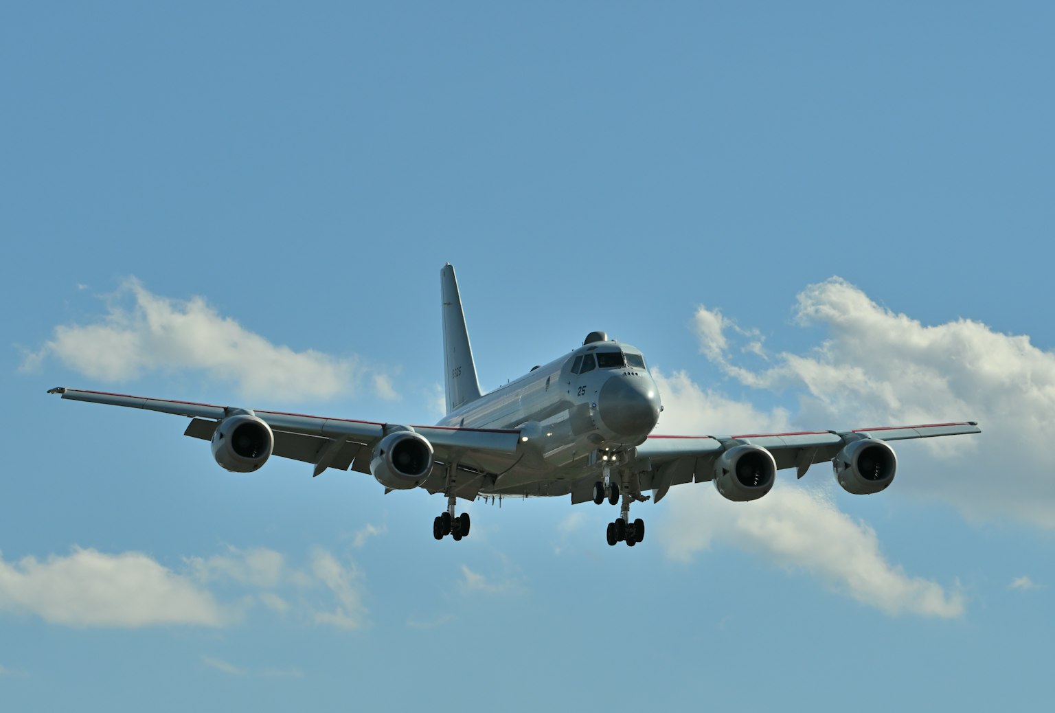 A large passenger airplane landing against a blue sky
