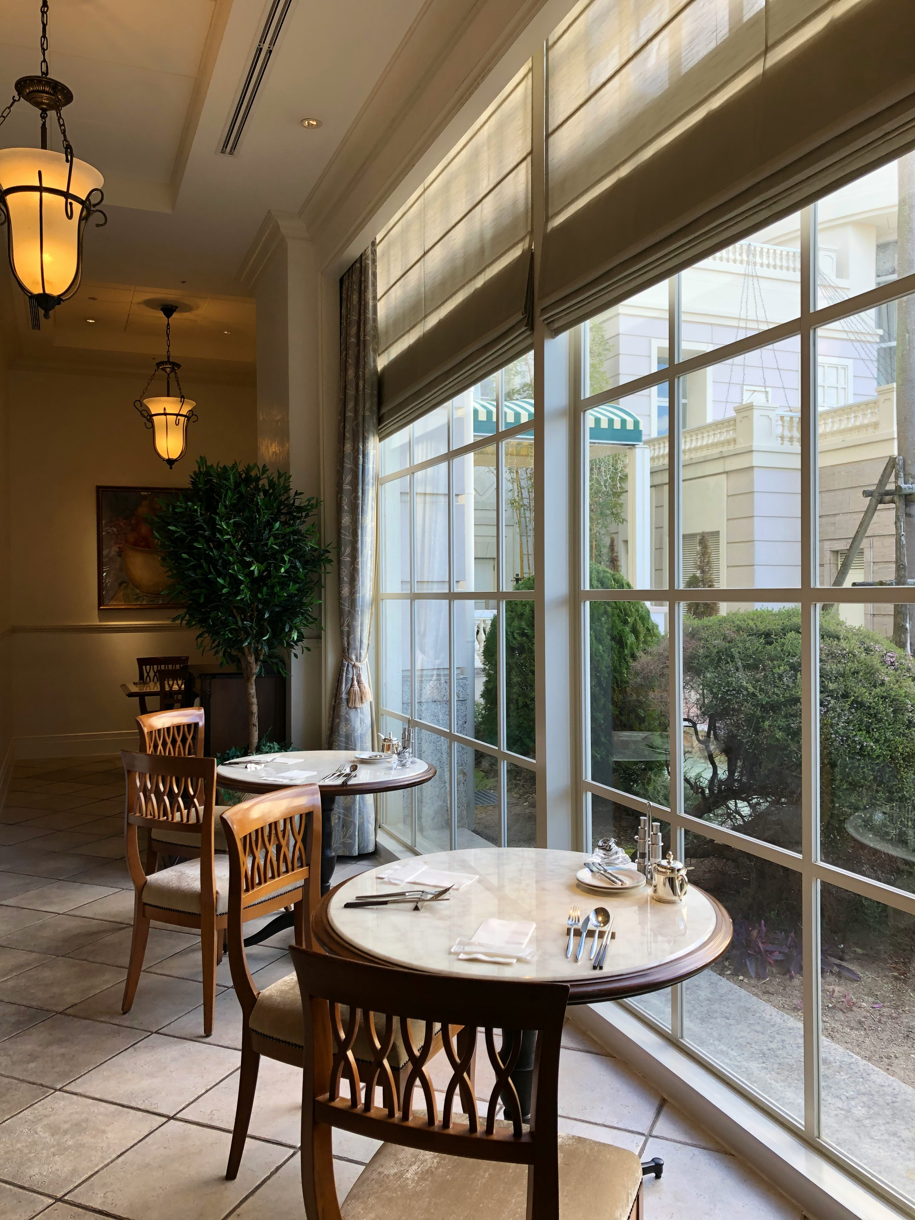 bright dining room table and chairs by large windows