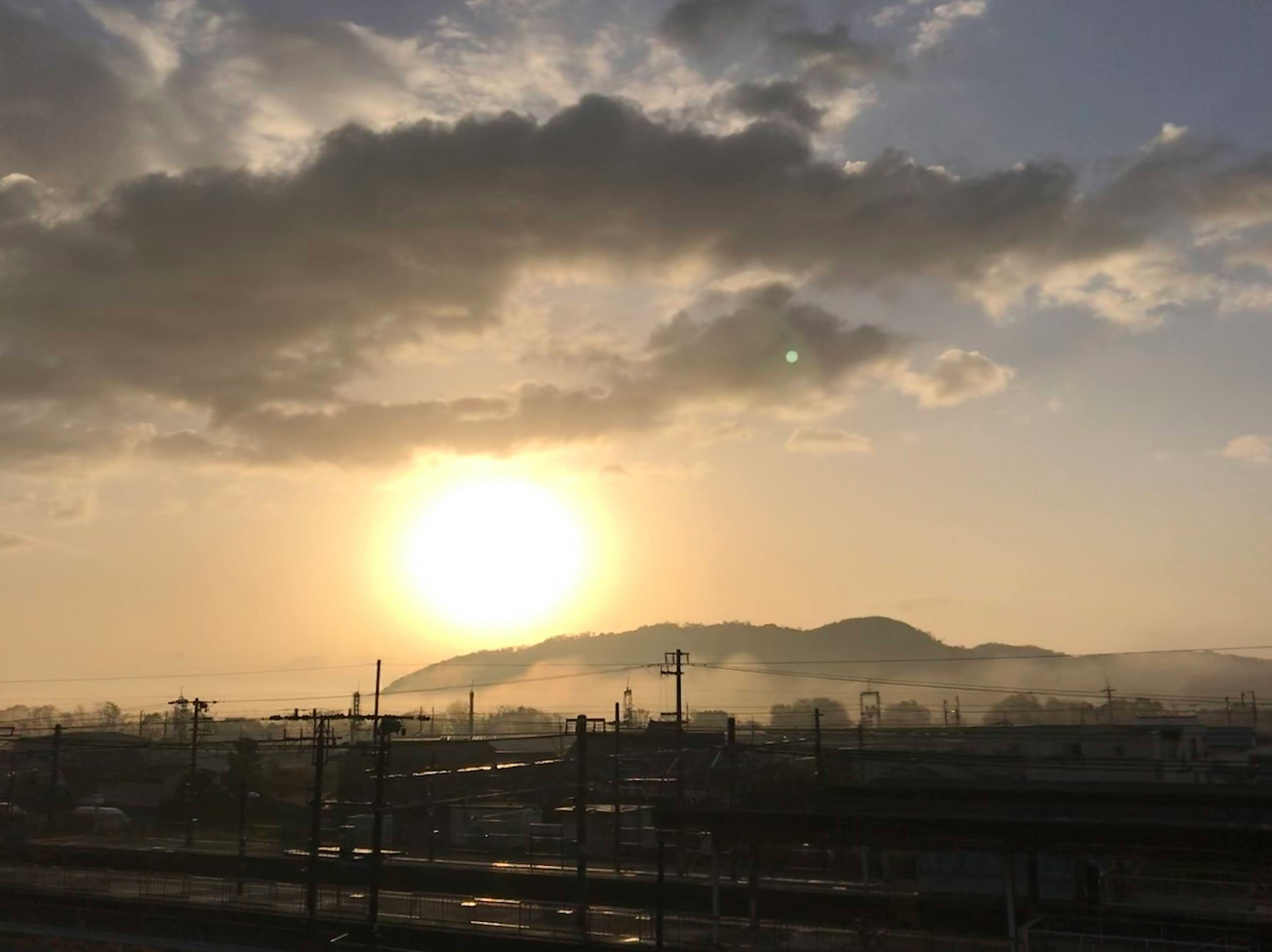suburban railway tracks under a sunset sky