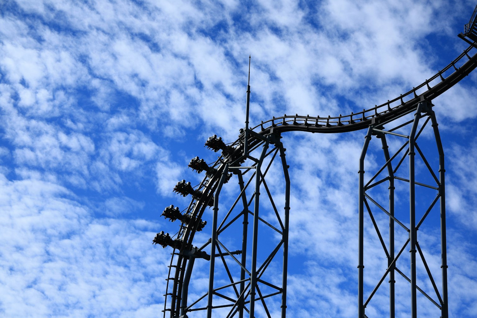 Part of a roller coaster against a blue sky