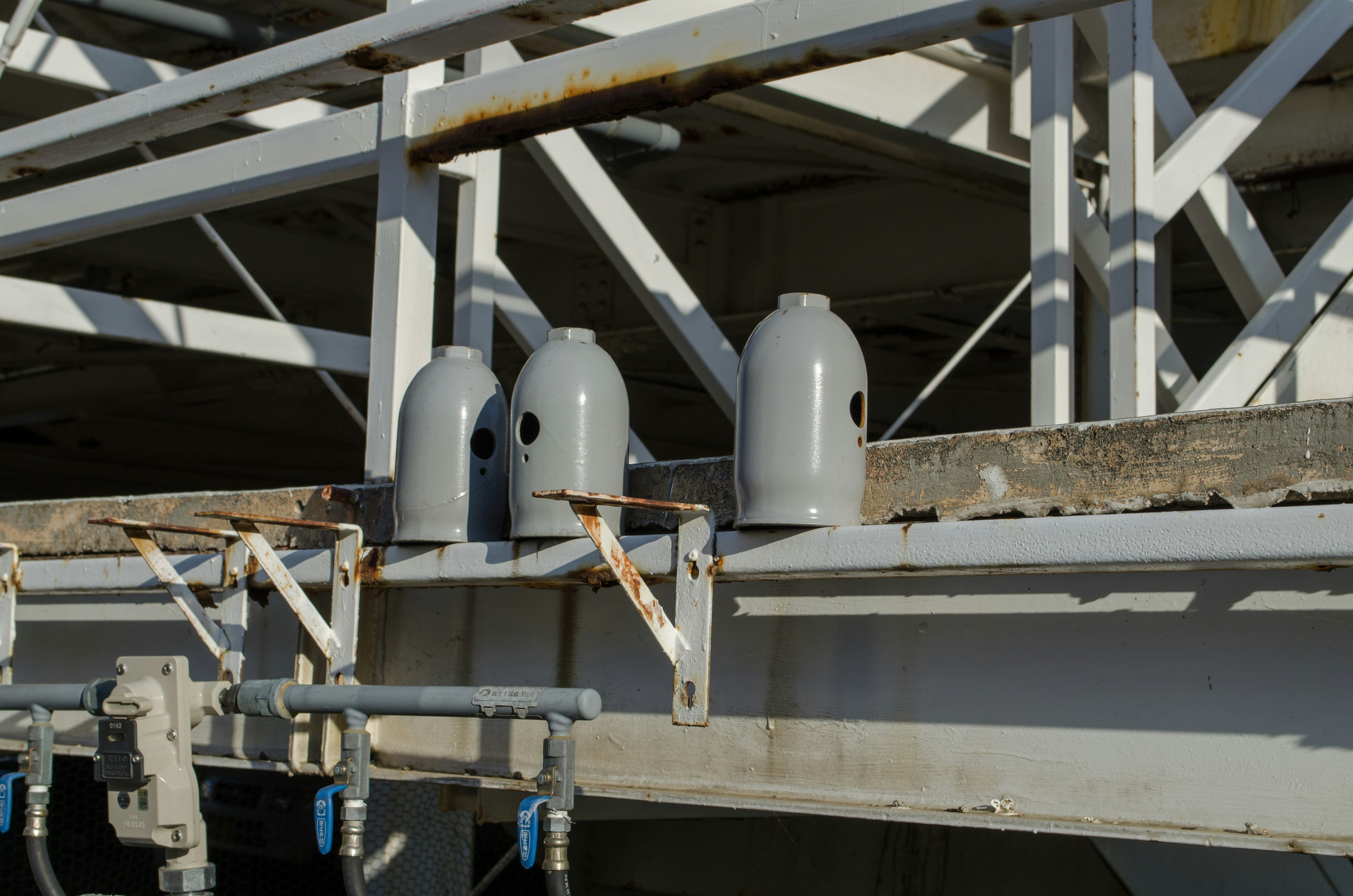 white pipes and equipment lined under a roof