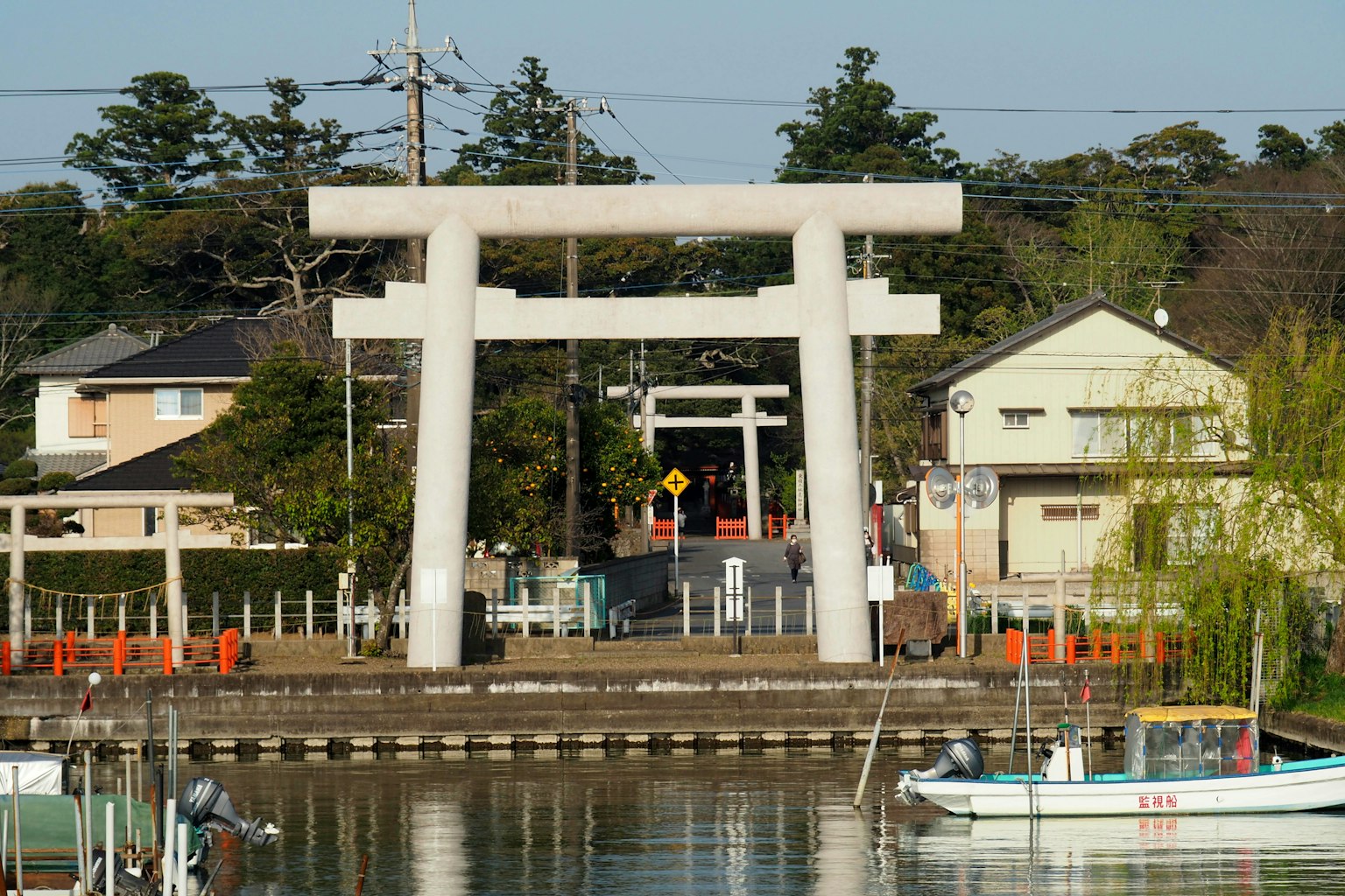 Large torii gate with a tranquil water surface