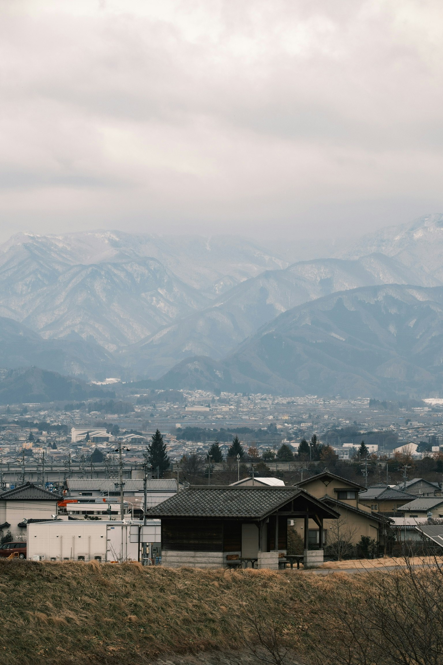 Scenic village landscape surrounded by mountains with old houses scattered