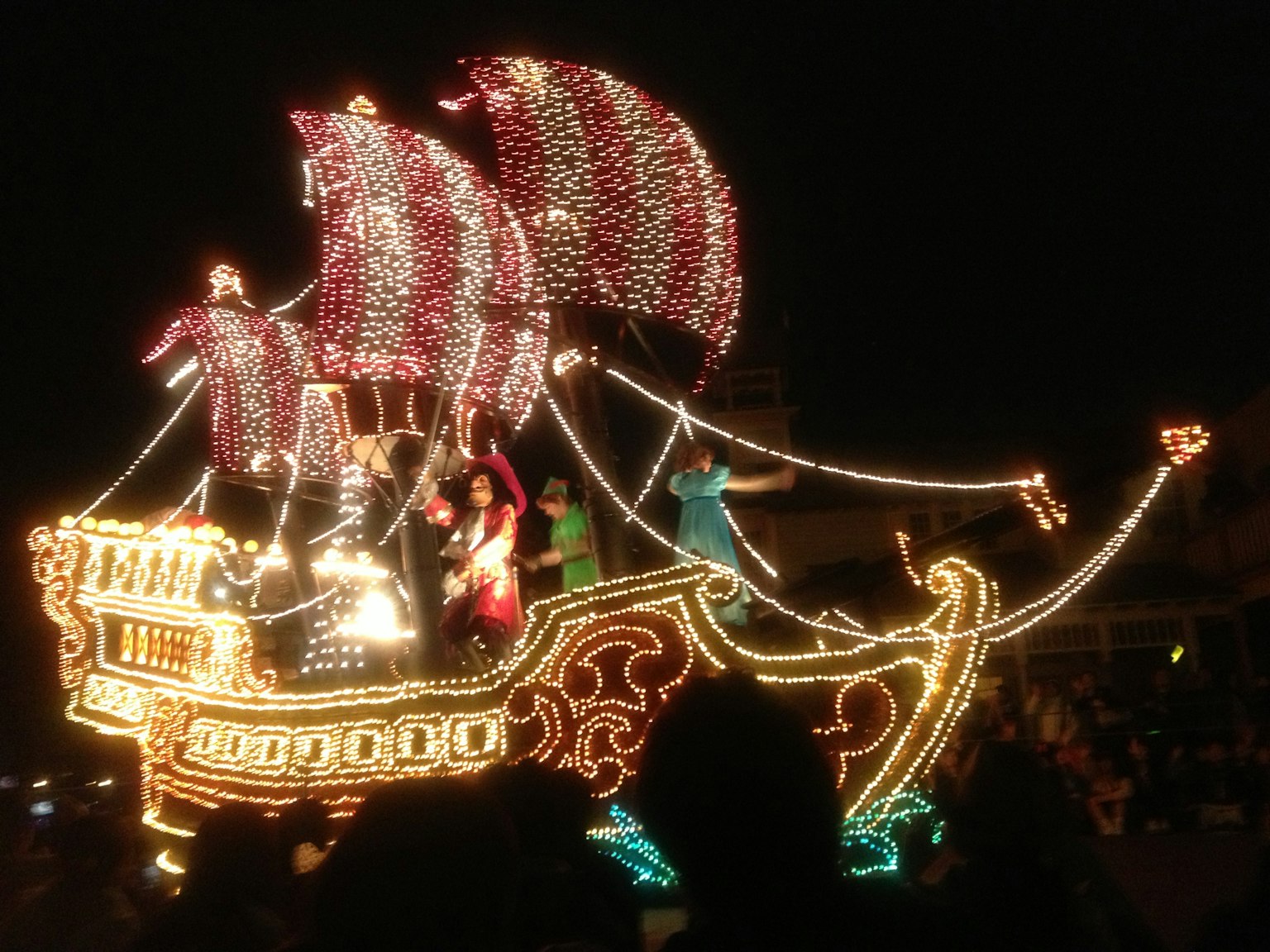 Decorative ship illuminated with lights during a night parade