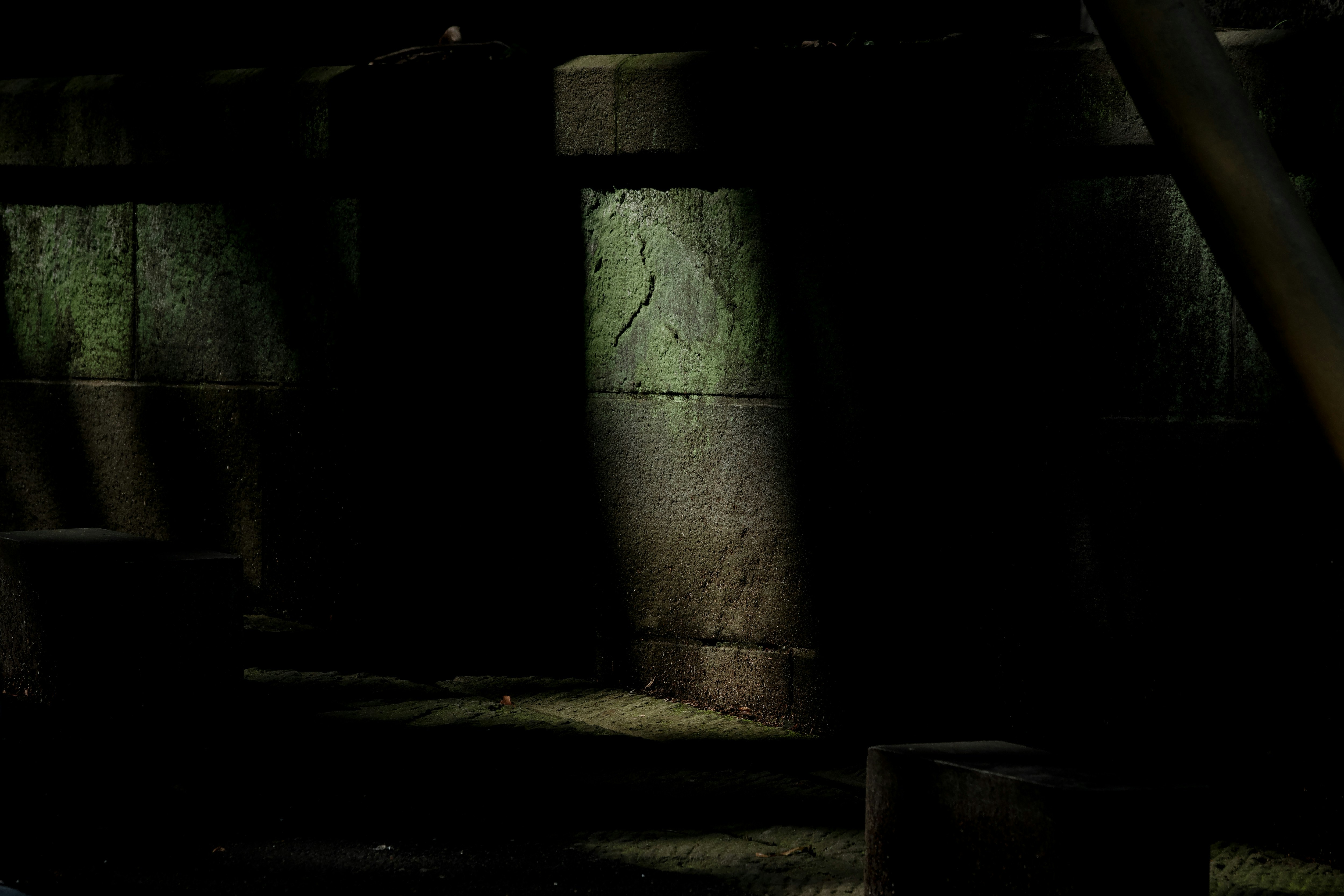 barrel and light-and-shadow in a dark stone alley