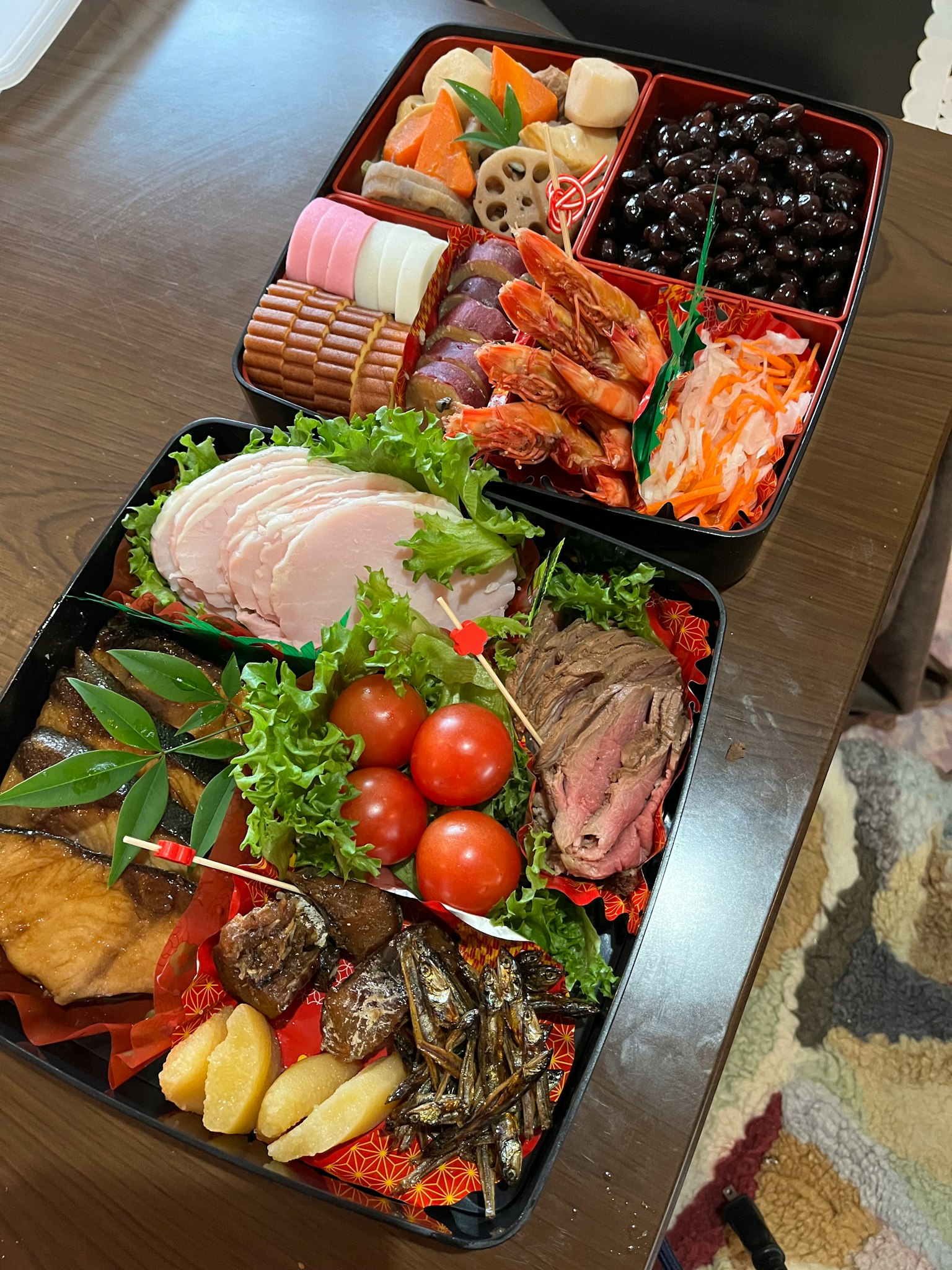A beautiful display of traditional Japanese osechi cuisine in a two-tier bento box