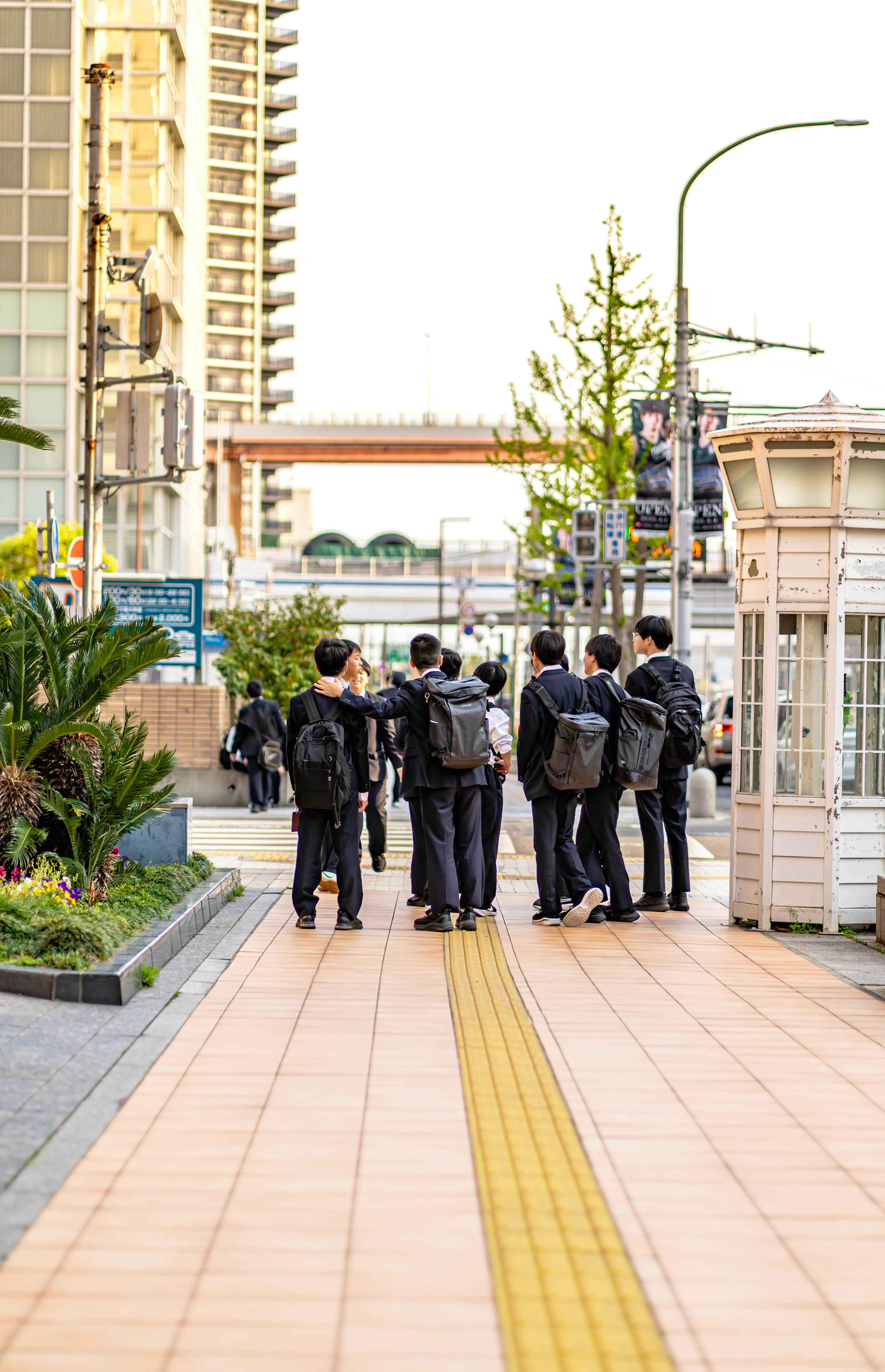 group of students walking along a station walkway