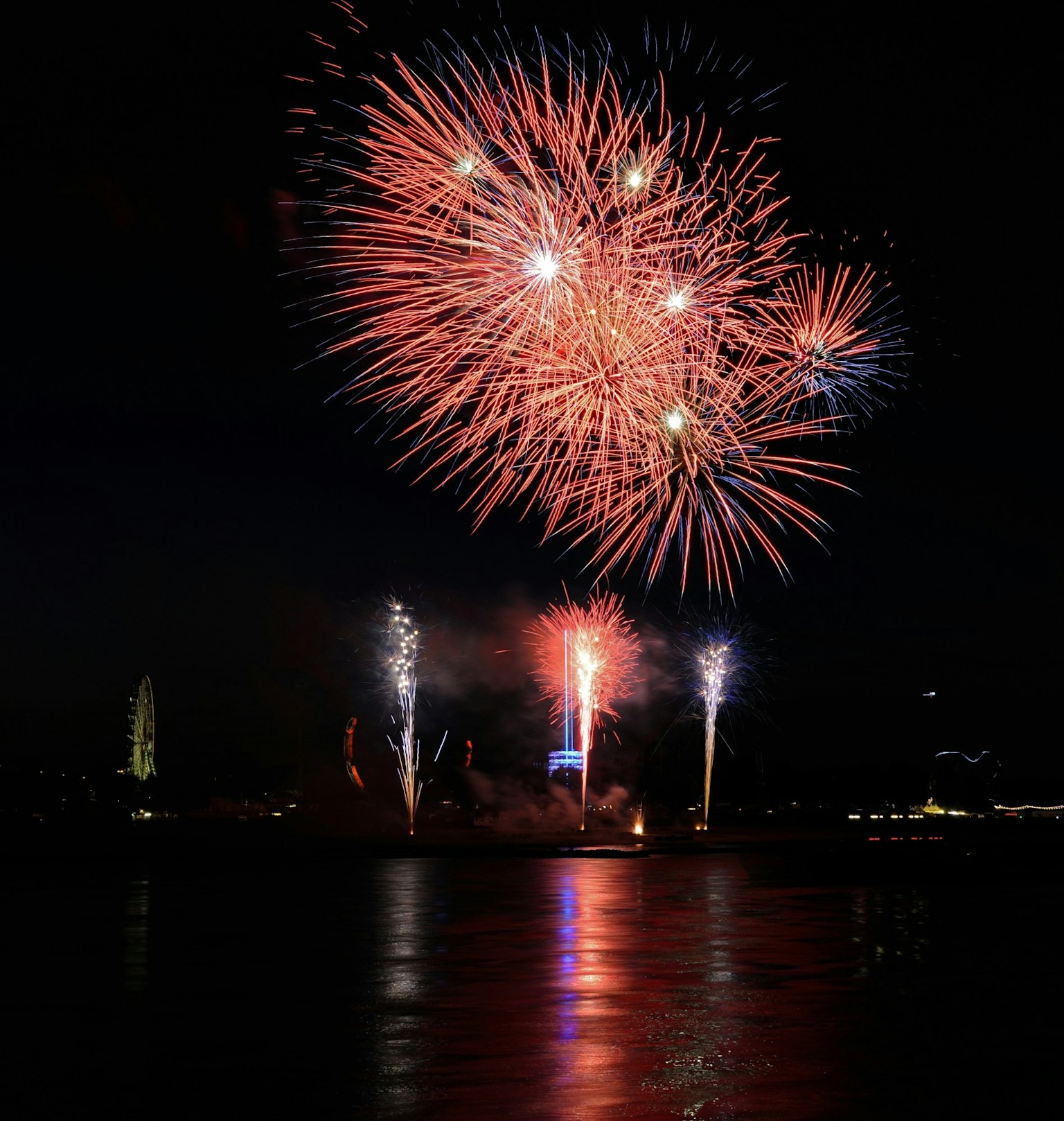 Beautiful fireworks display in the night sky vibrant red and blue colors shining