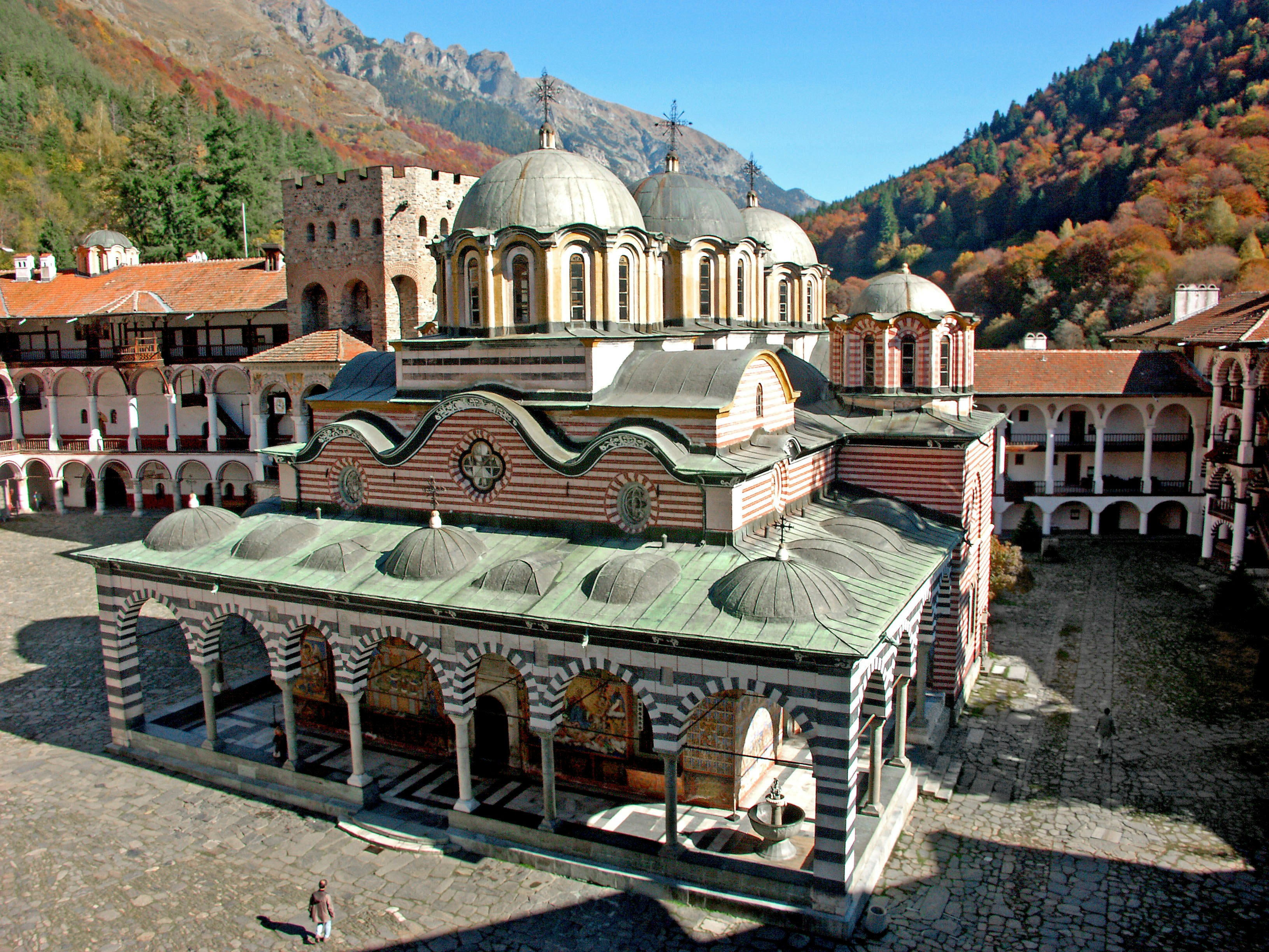 dome-roof temple complex with mountain backdrop