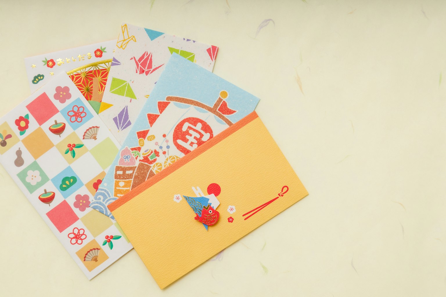 Bunte gemusterte Schreibwaren und ein orangefarbenes Kuvert sind ausgestellt