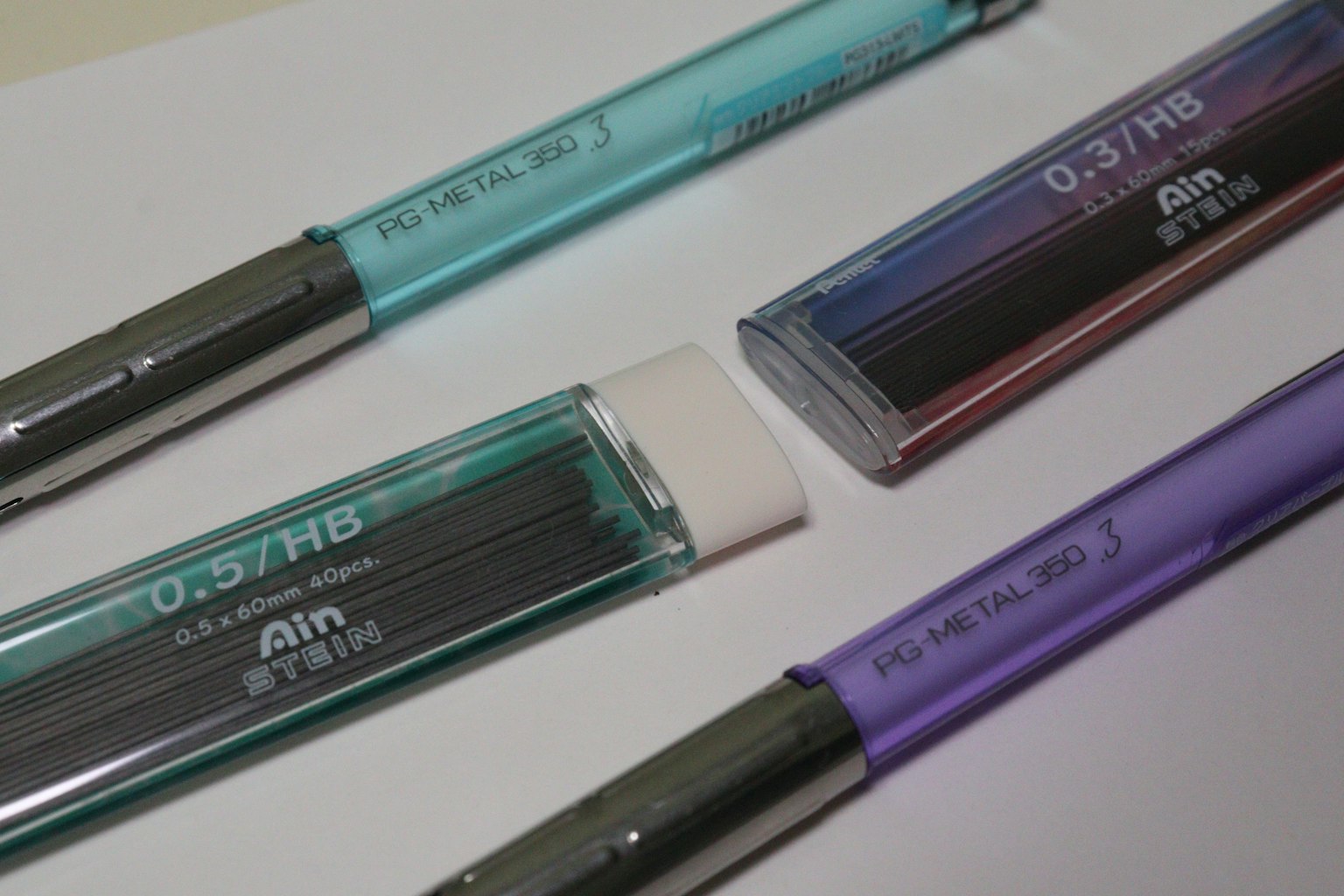 Un conjunto de lápices mecánicos coloridos dispuestos sobre un fondo blanco