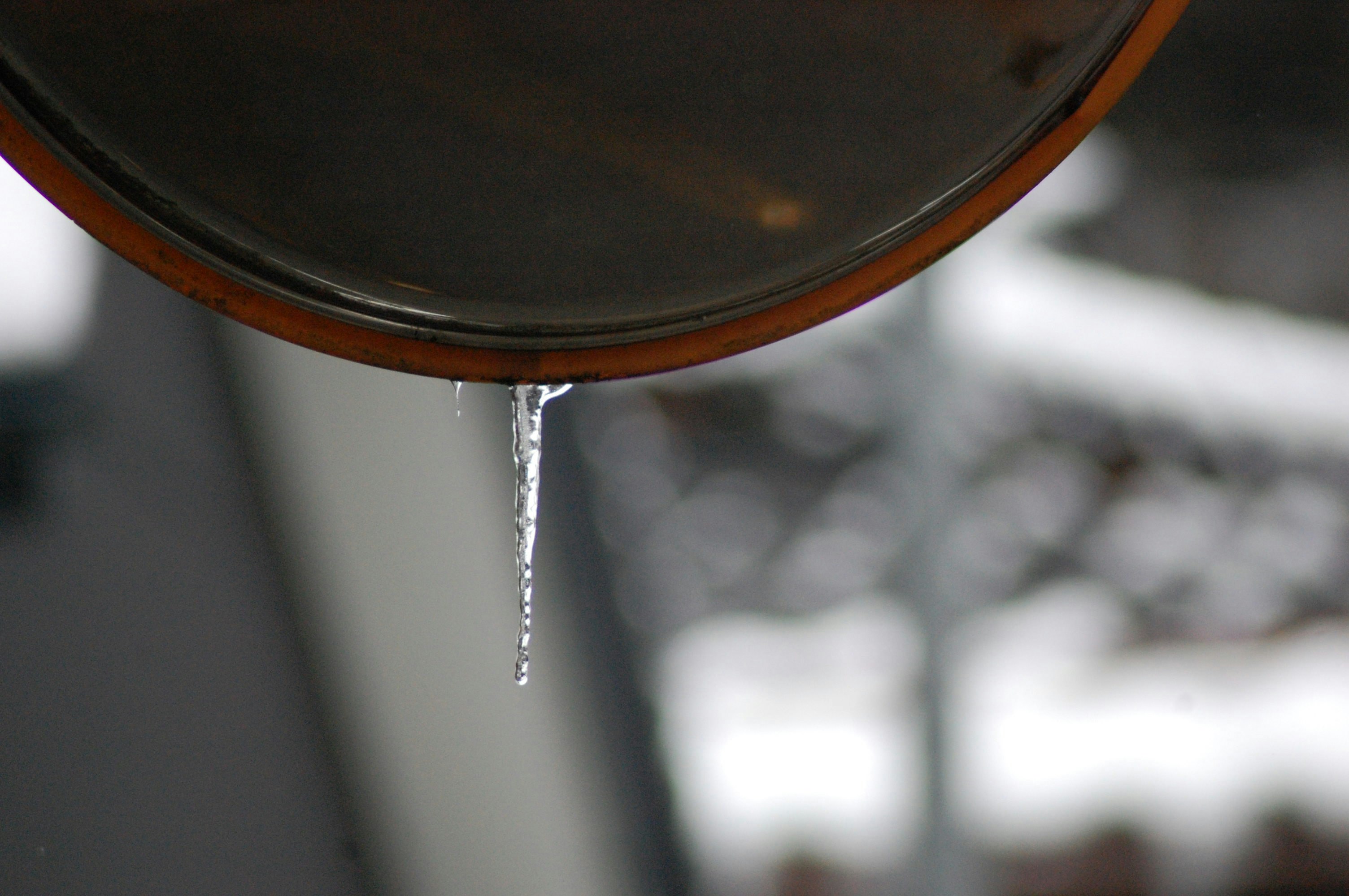metal utensil with water droplets hanging from the rim