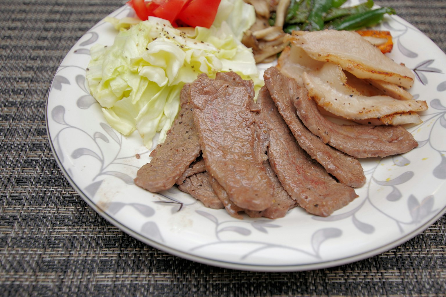 Assiette avec de la viande tranchée et des garnitures de salade