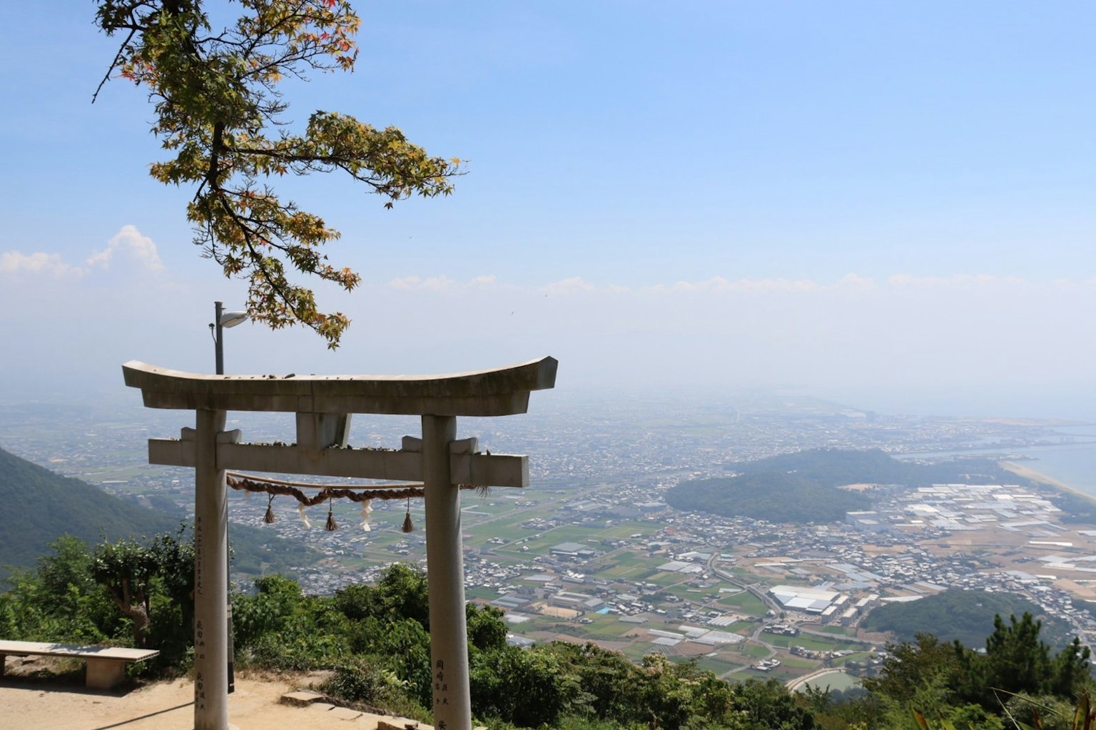 Torii gate overlooking a scenic mountain landscape