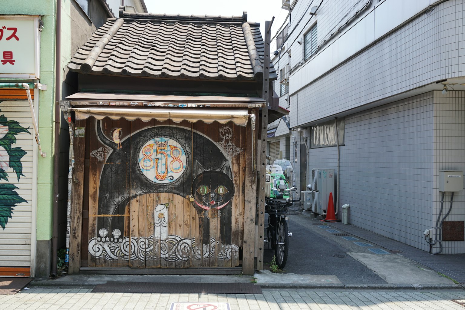 Exterior of an old building with a wooden door and colorful decorations