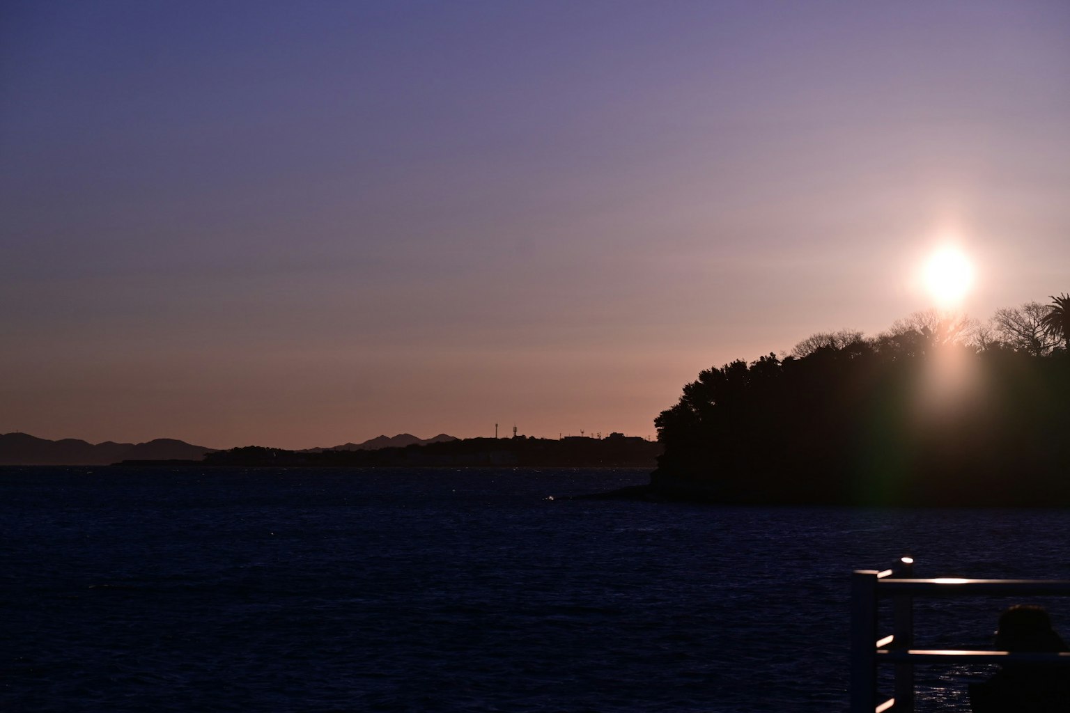 Sunset over the sea with a silhouette of an island
