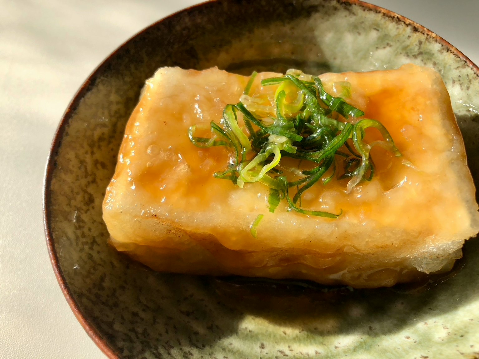 Delicious tofu dish served on a green plate