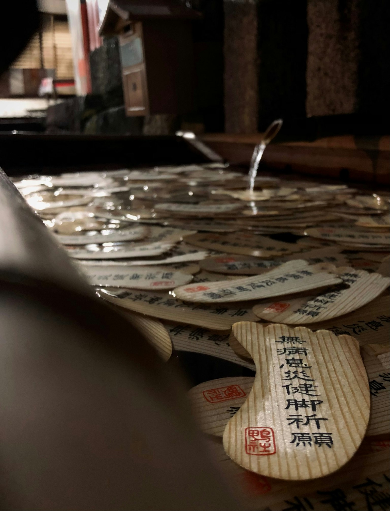 A shot of numerous wooden plaques arranged in a dark environment