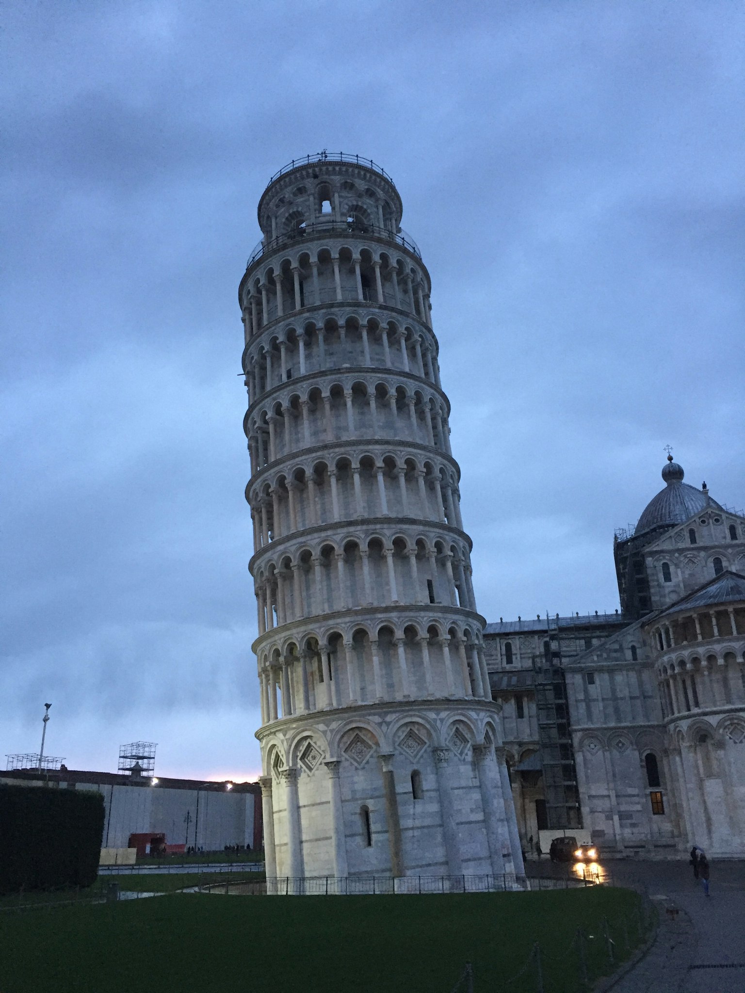 Leaning Tower of Pisa at dusk featuring its iconic white limestone structure and blue sky