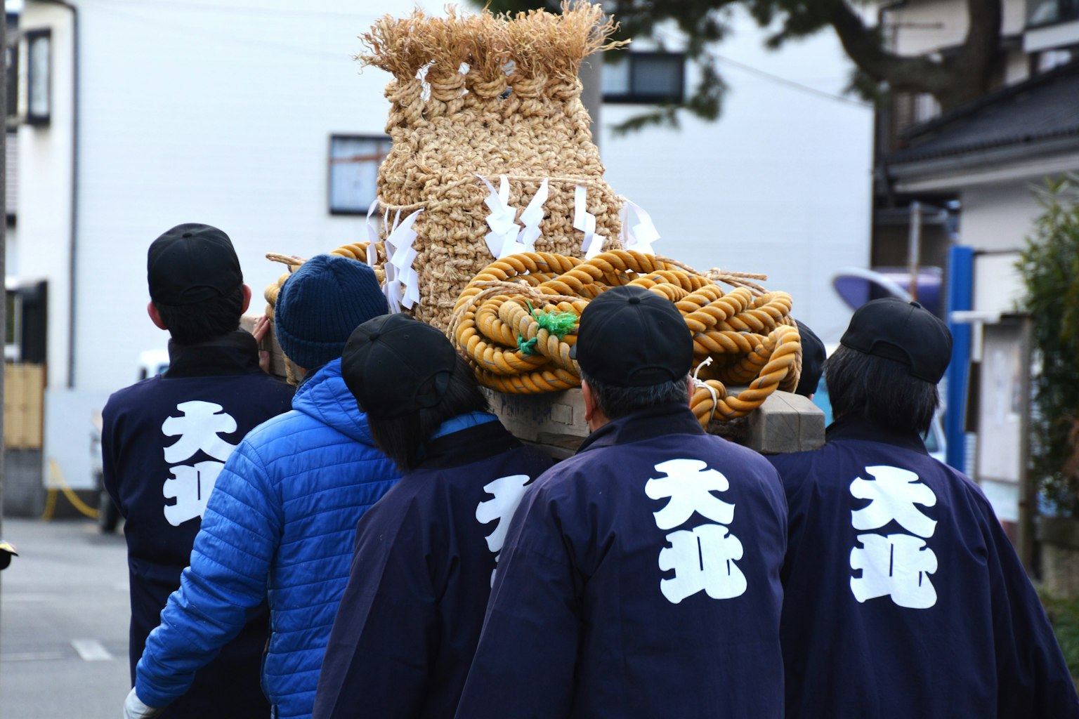 축제에서 전통 의상을 입고 이동식 신사를 운반하는 참가자들