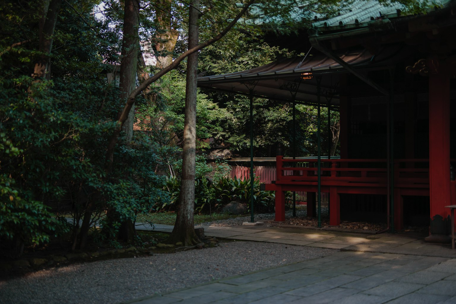 Quiet Japanese garden featuring a red structure and lush greenery