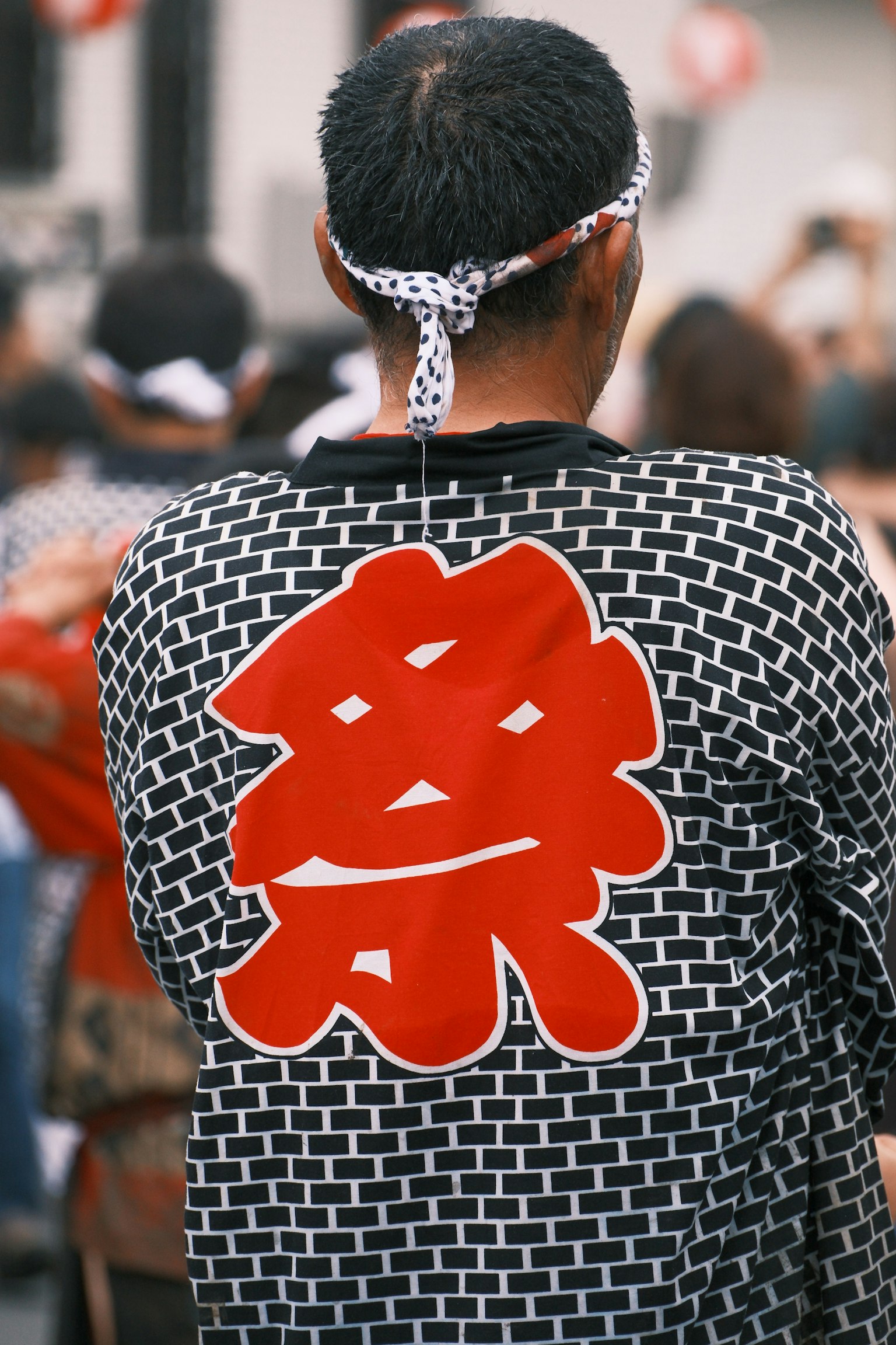 Man wearing a festival outfit with red kanji on the back