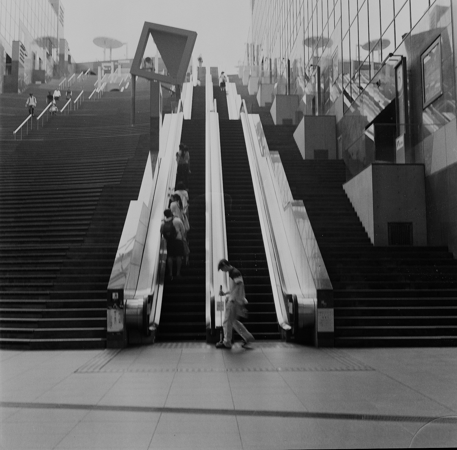 Innenraum eines modernen Gebäudes mit parallelen Rolltreppen und Treppen