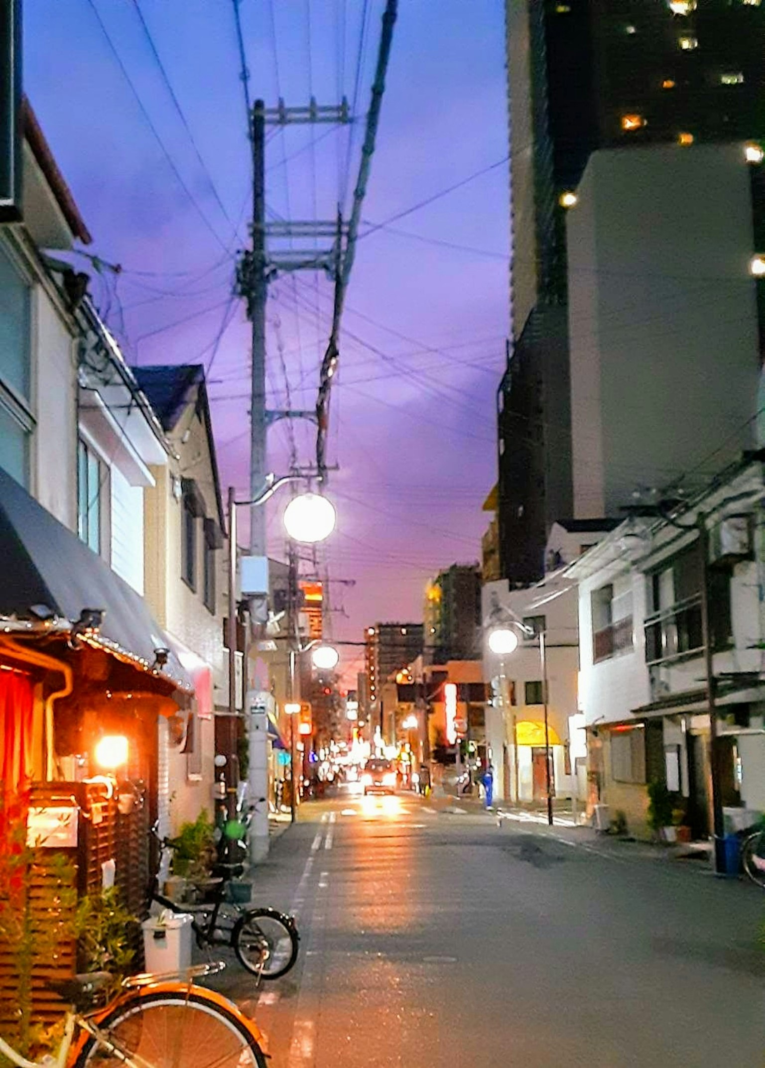 Quiet street scene with purple sunset sky