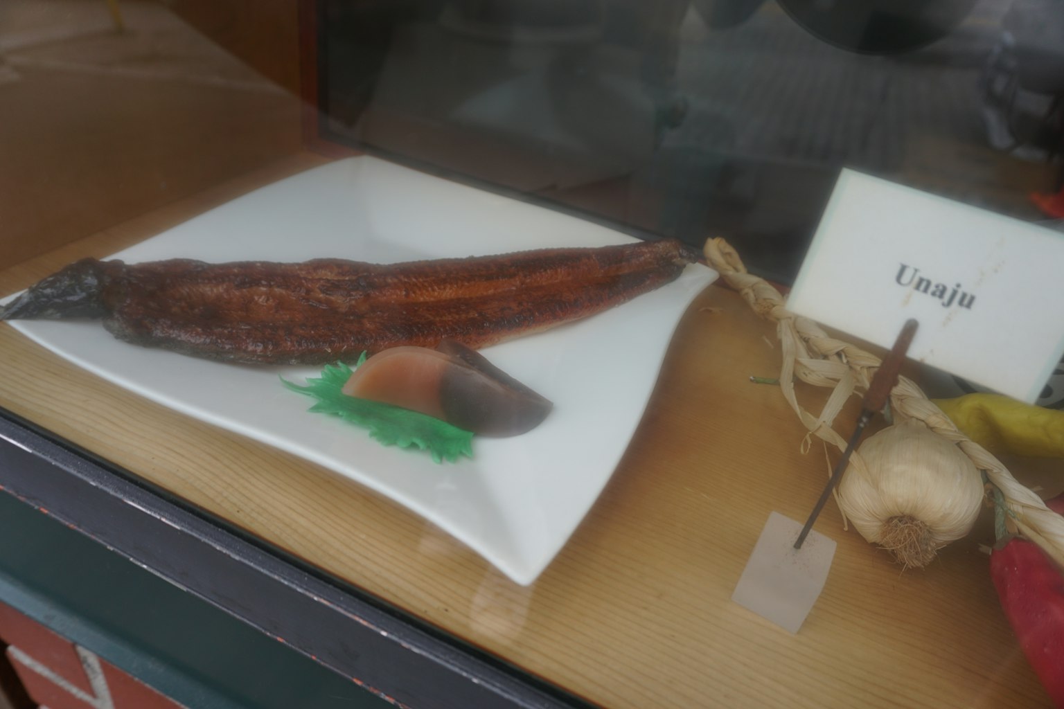 棕色烤魚擺放在白色盤子上，配有綠色裝飾