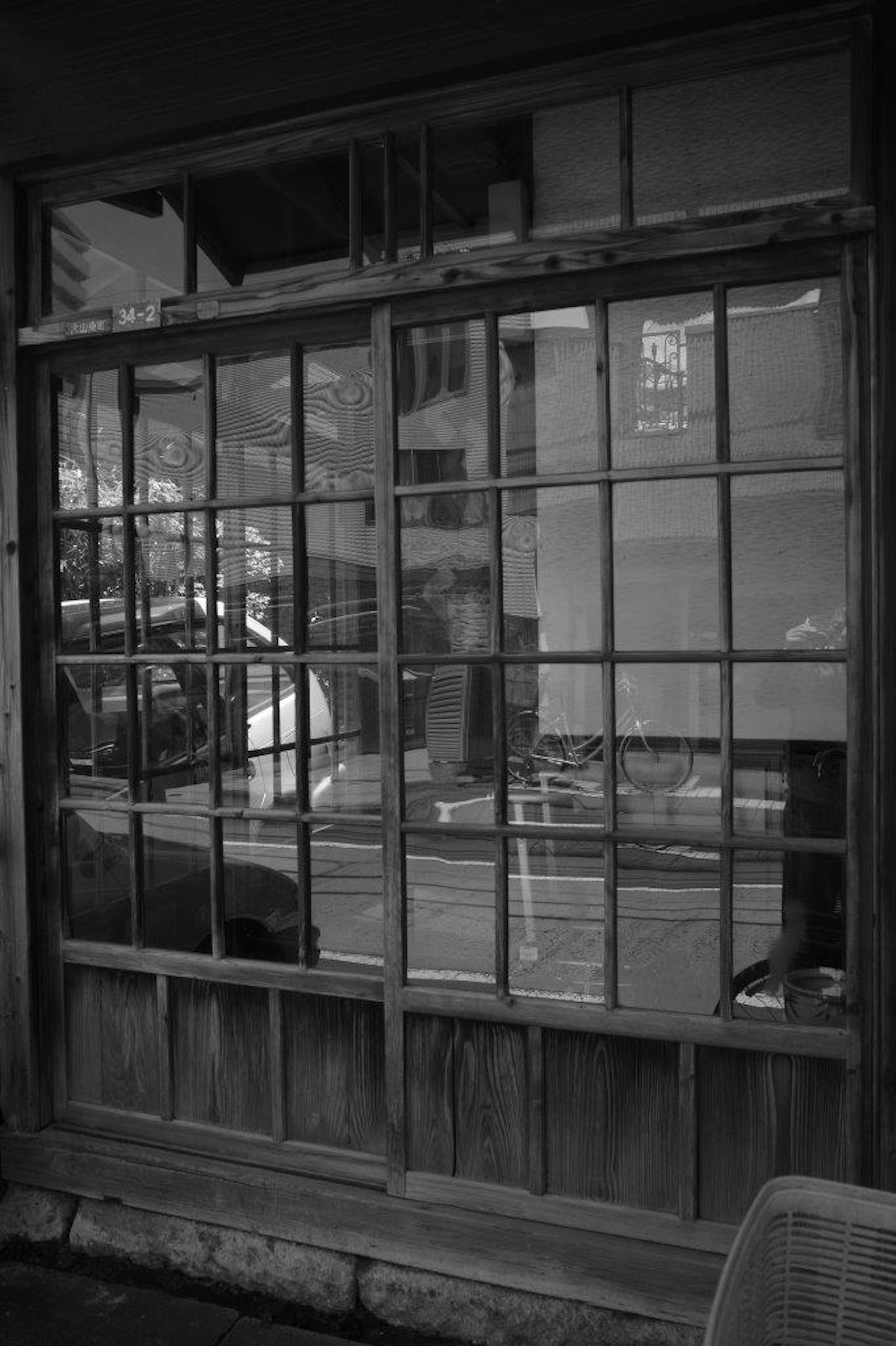 Old wooden window with reflections in black and white