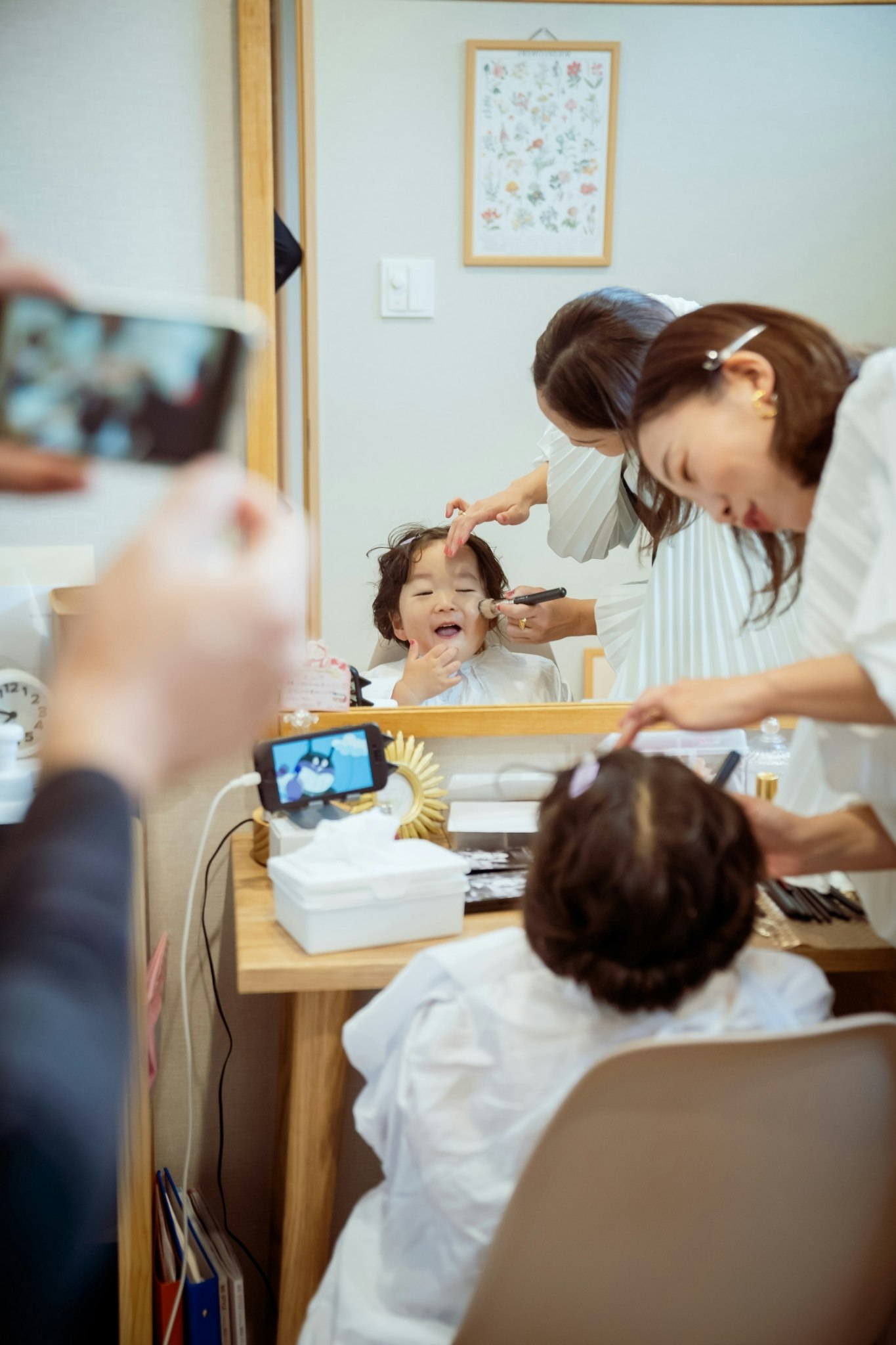 子どものヘアカットを見守る親子の美容室風景