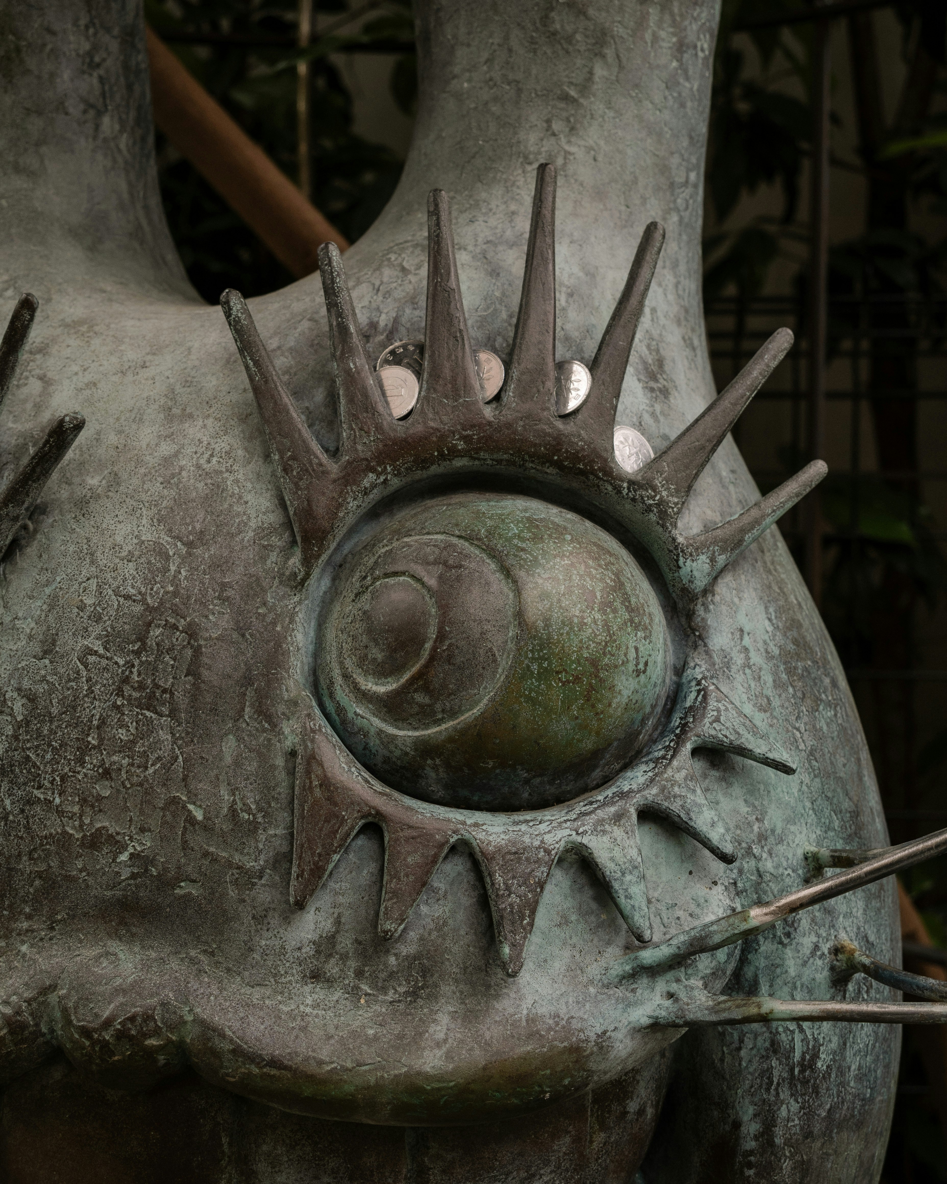 close-up of a spiked metal statue face