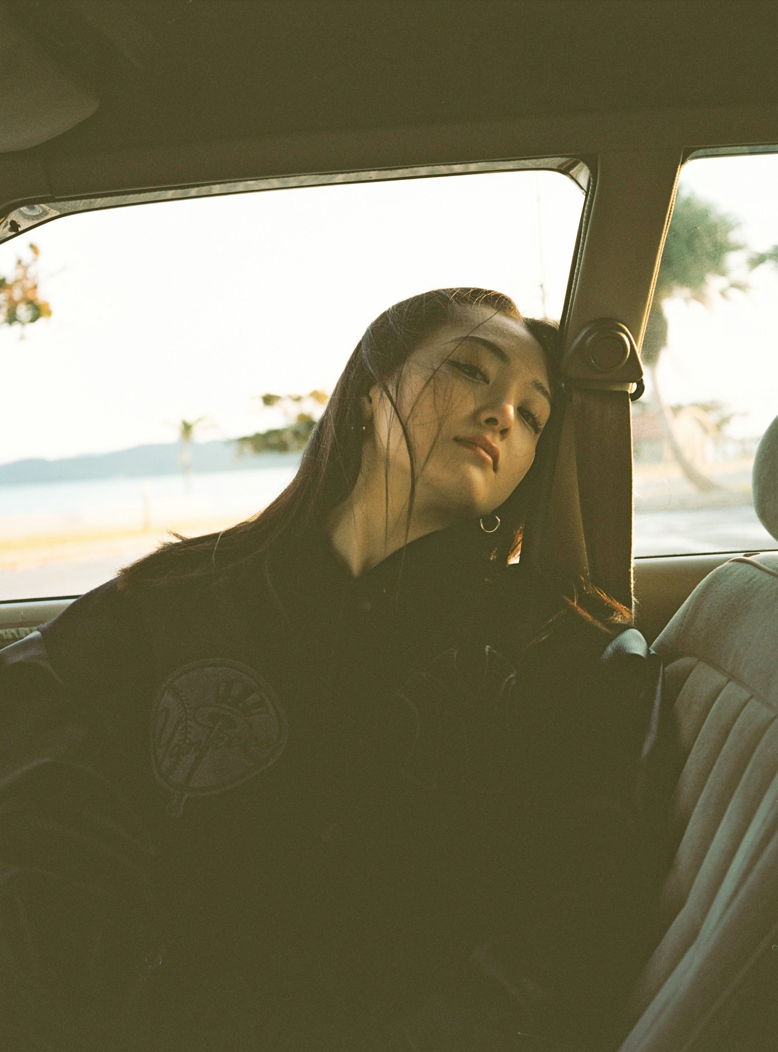 Side profile of a woman sitting peacefully in a car