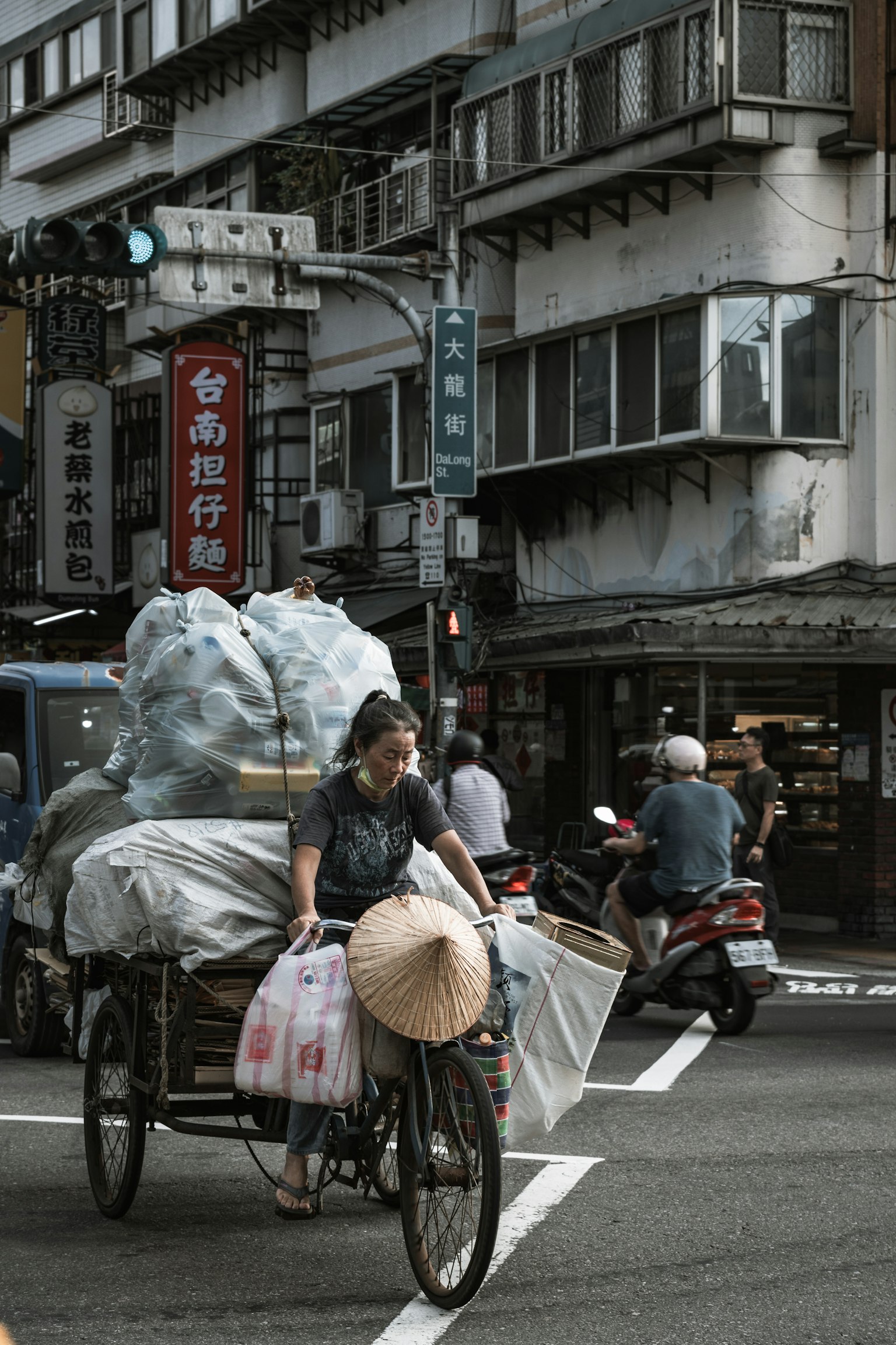 自転車に乗った女性が荷物を運ぶ街の風景