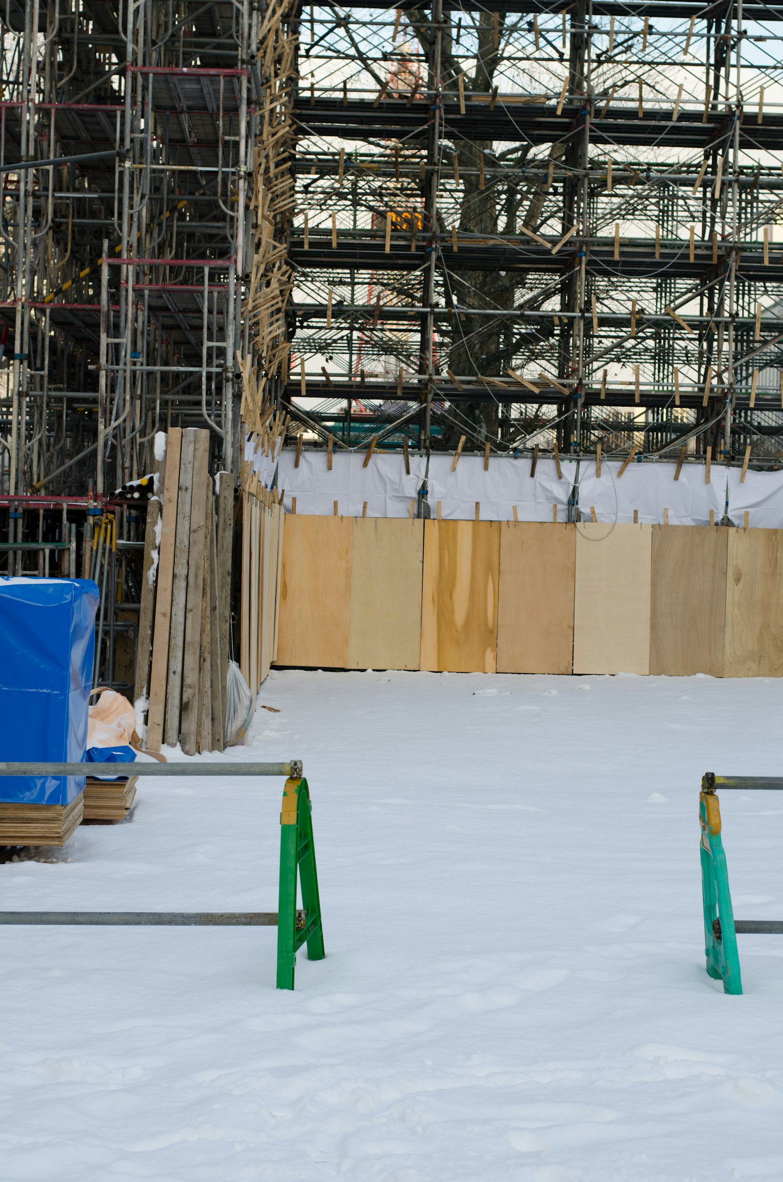 Construction site featuring scaffolding and snow-covered ground